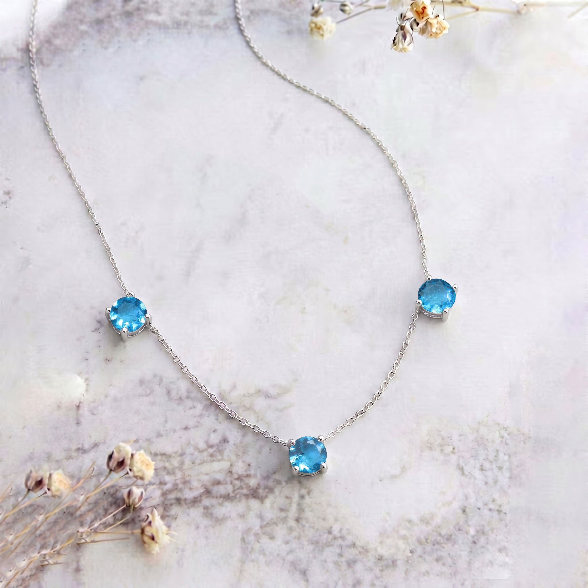 Three stone Blue Topaz necklace designed with a timeless style for everyday and special occasions.
