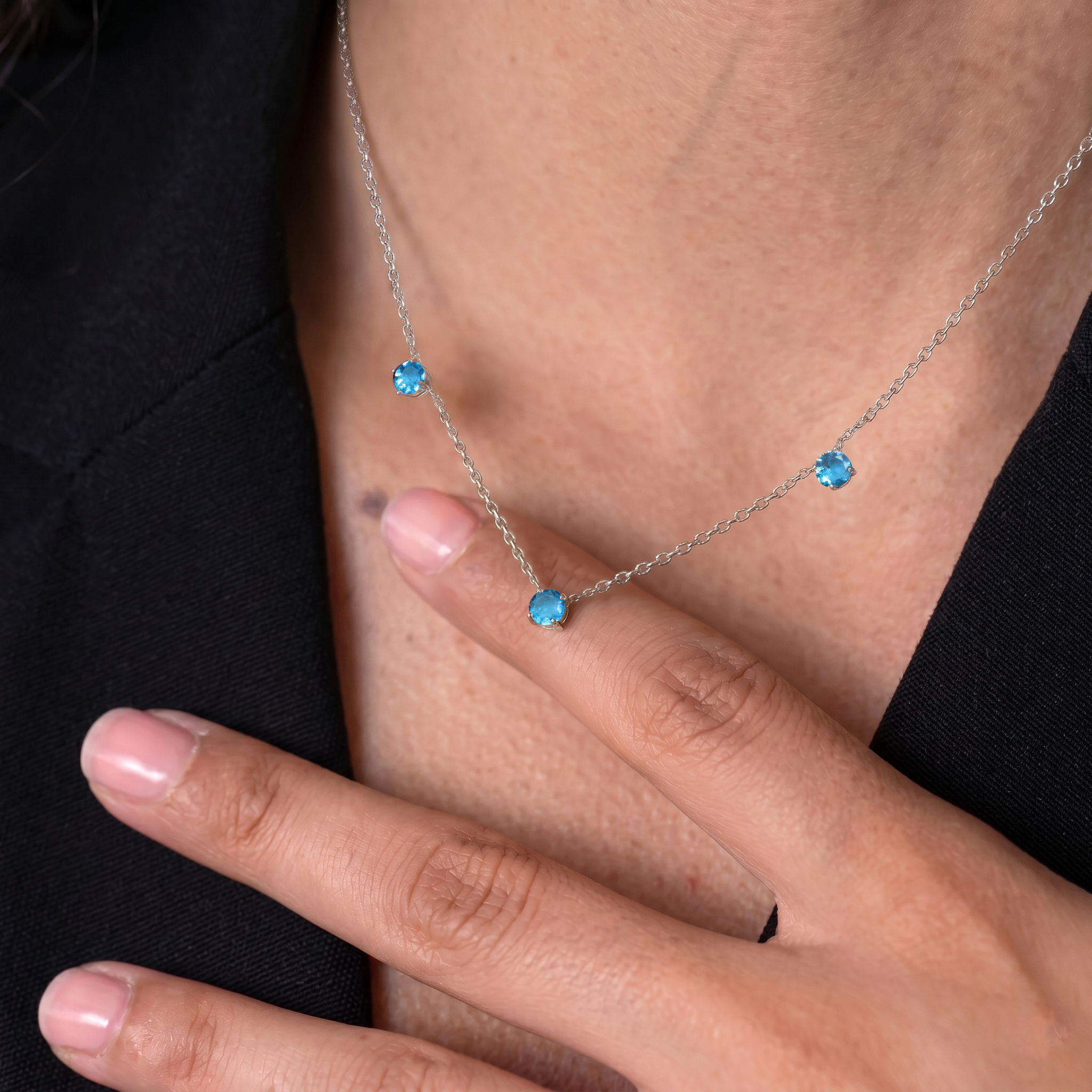 Sterling Silver Blue Topaz station necklace featuring beautiful blue gemstones and a classic design.
