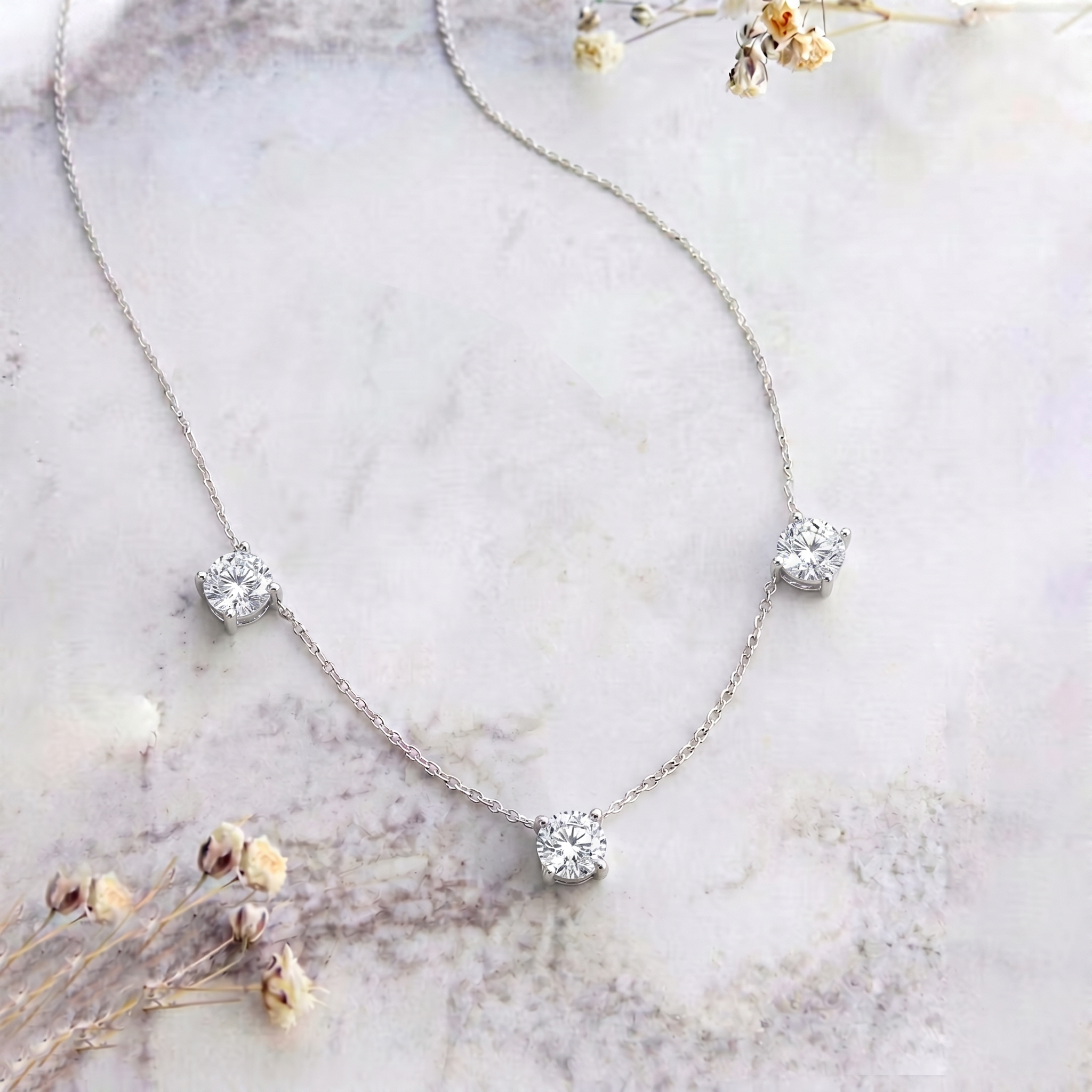 Sparkling Moissanite gemstone necklace featuring three round stones for women.

