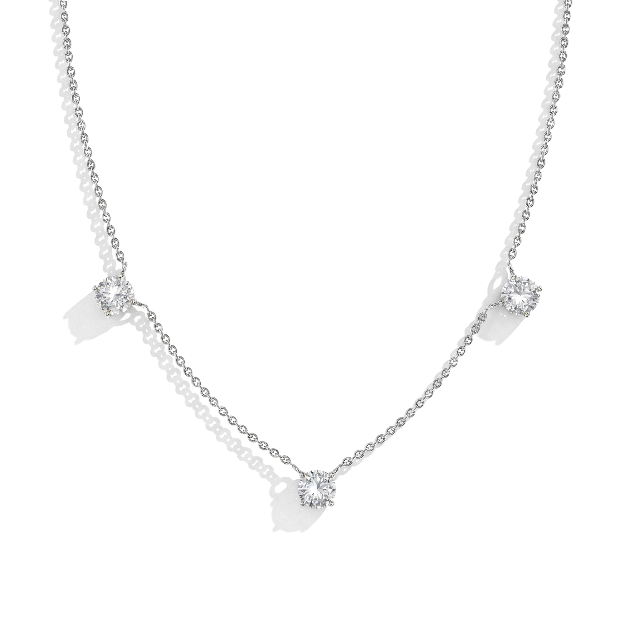 "Dainty Moissanite necklace featuring three round sparkling stones in 925 Sterling Silver.
