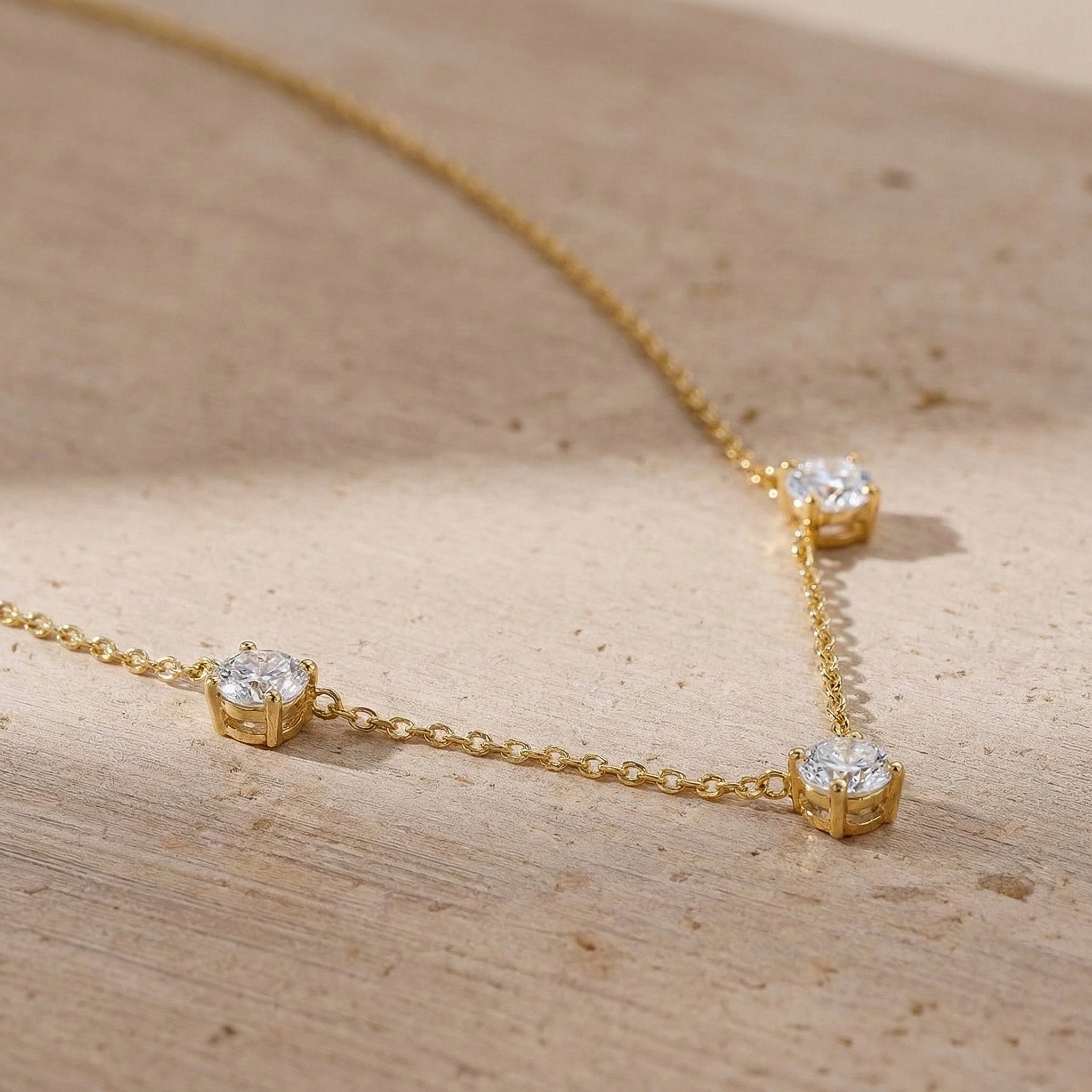 Women's fine jewelry Moissanite necklace with classic station setting.
