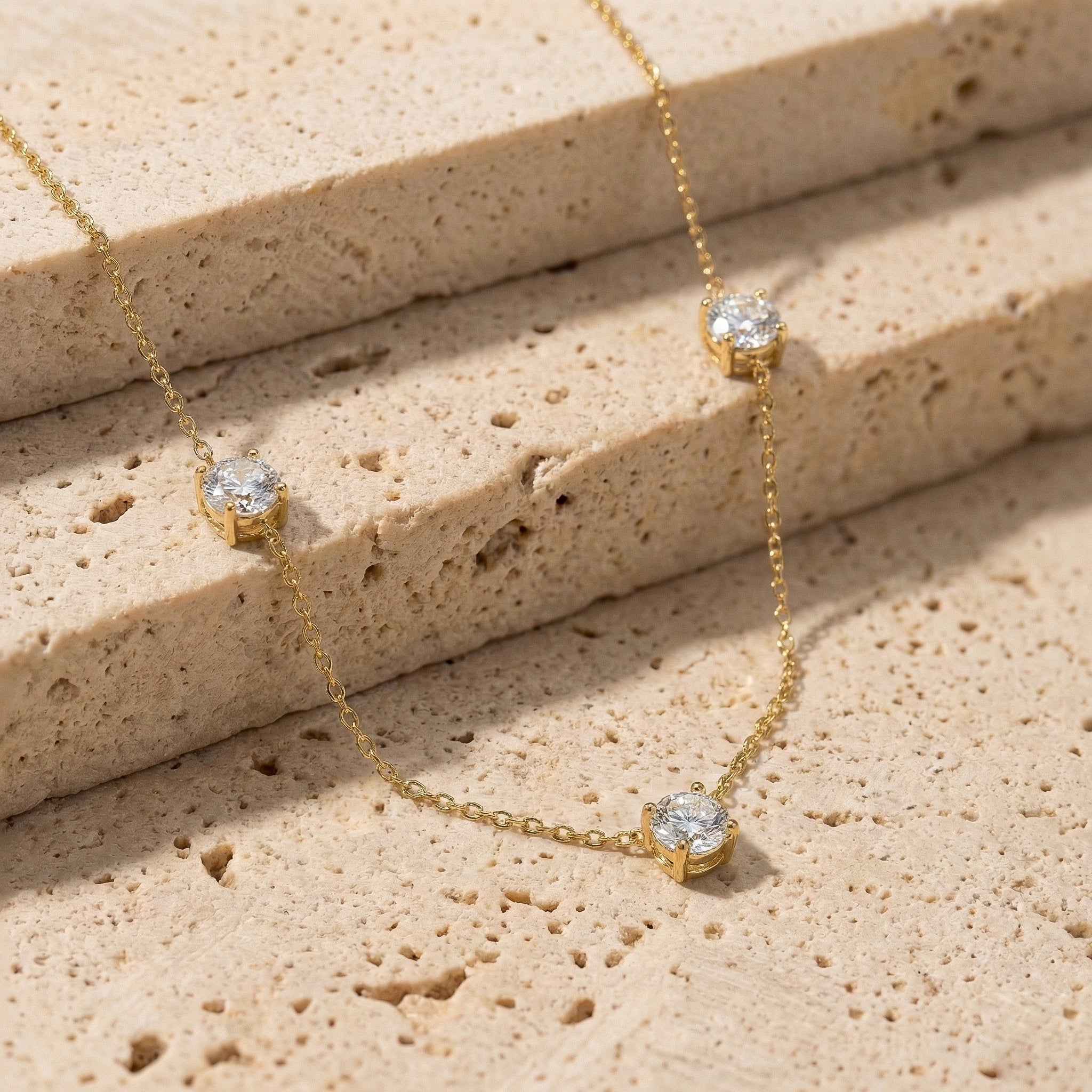 Three stone Moissanite necklace designed with a minimalist and timeless jewelry style.
