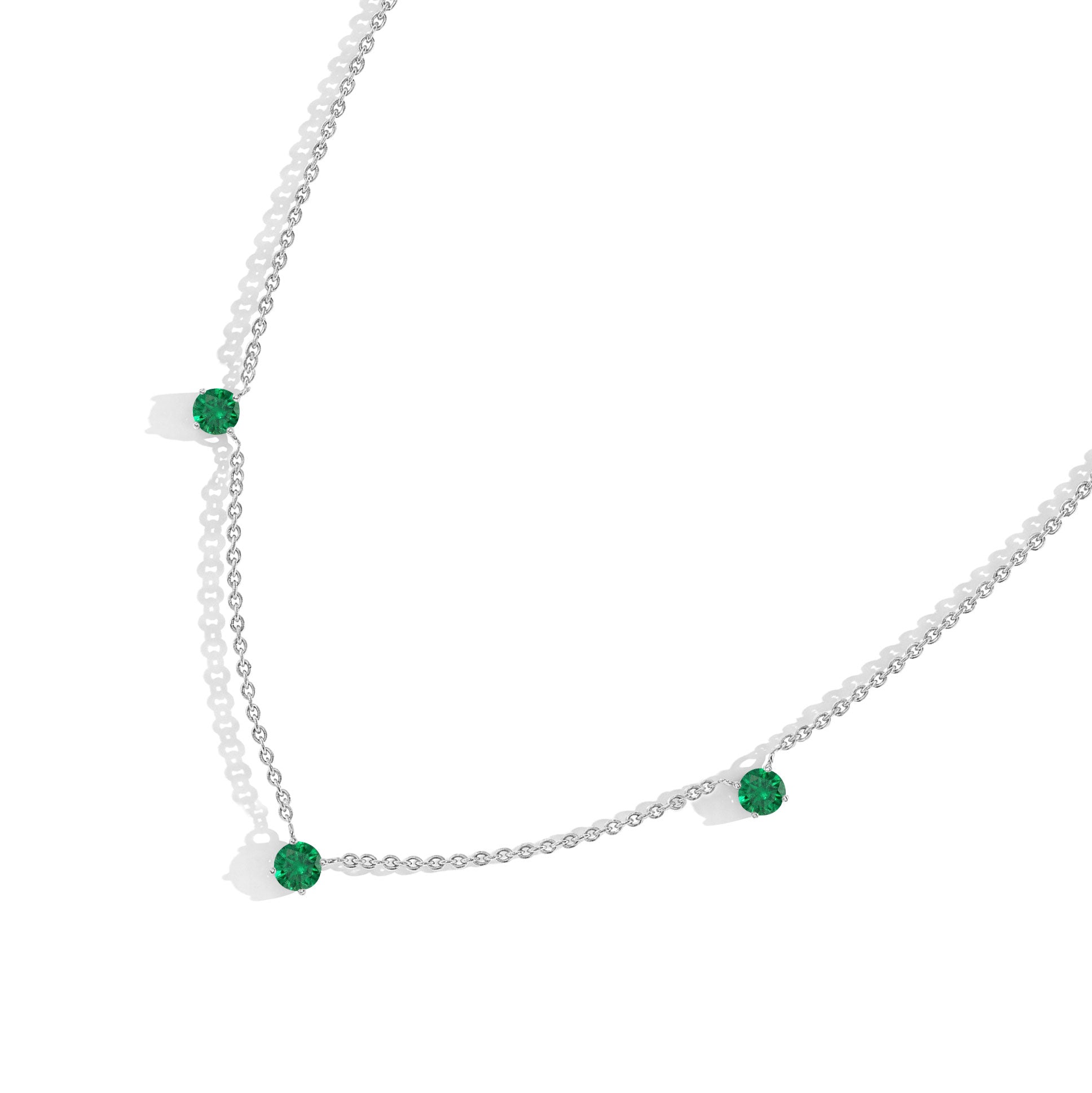 Elegant Emerald necklace with vibrant green gemstones and adjustable chain.
