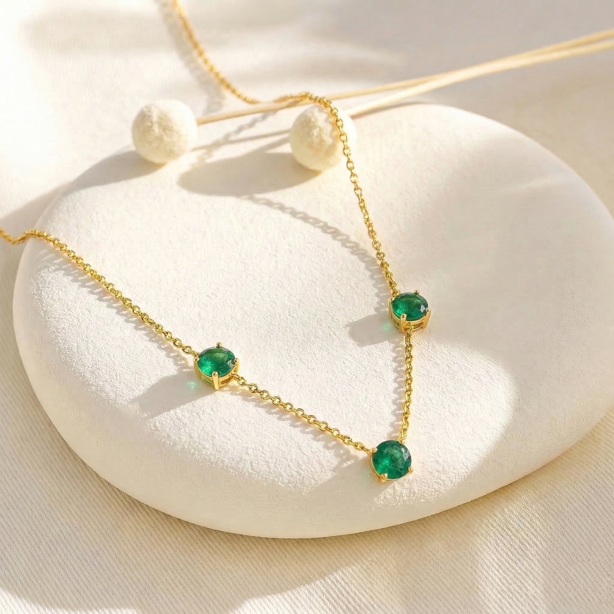 Women's fine jewelry Emerald necklace with classic station setting.
