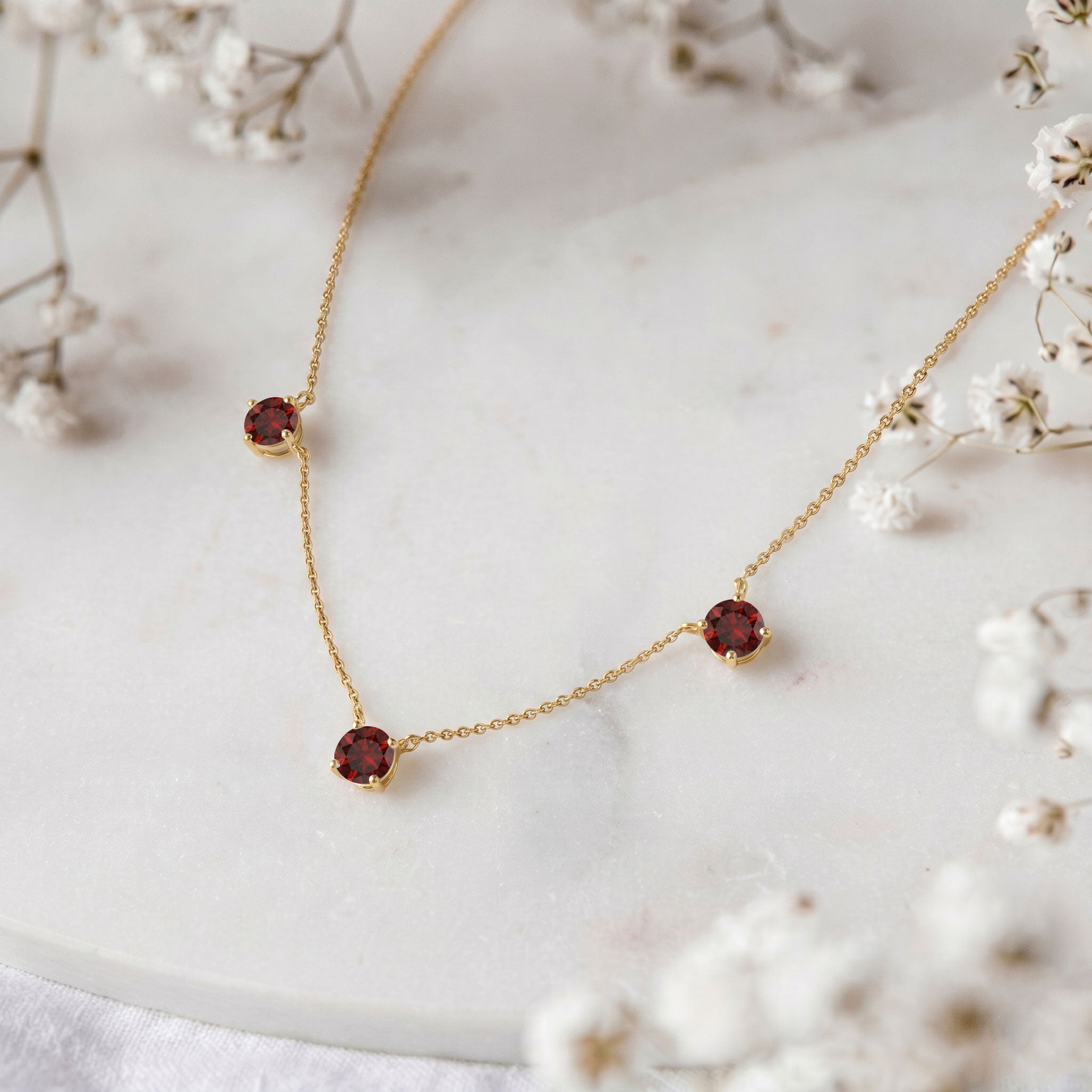 Genuine Garnet gemstone necklace featuring three round stones for women.
