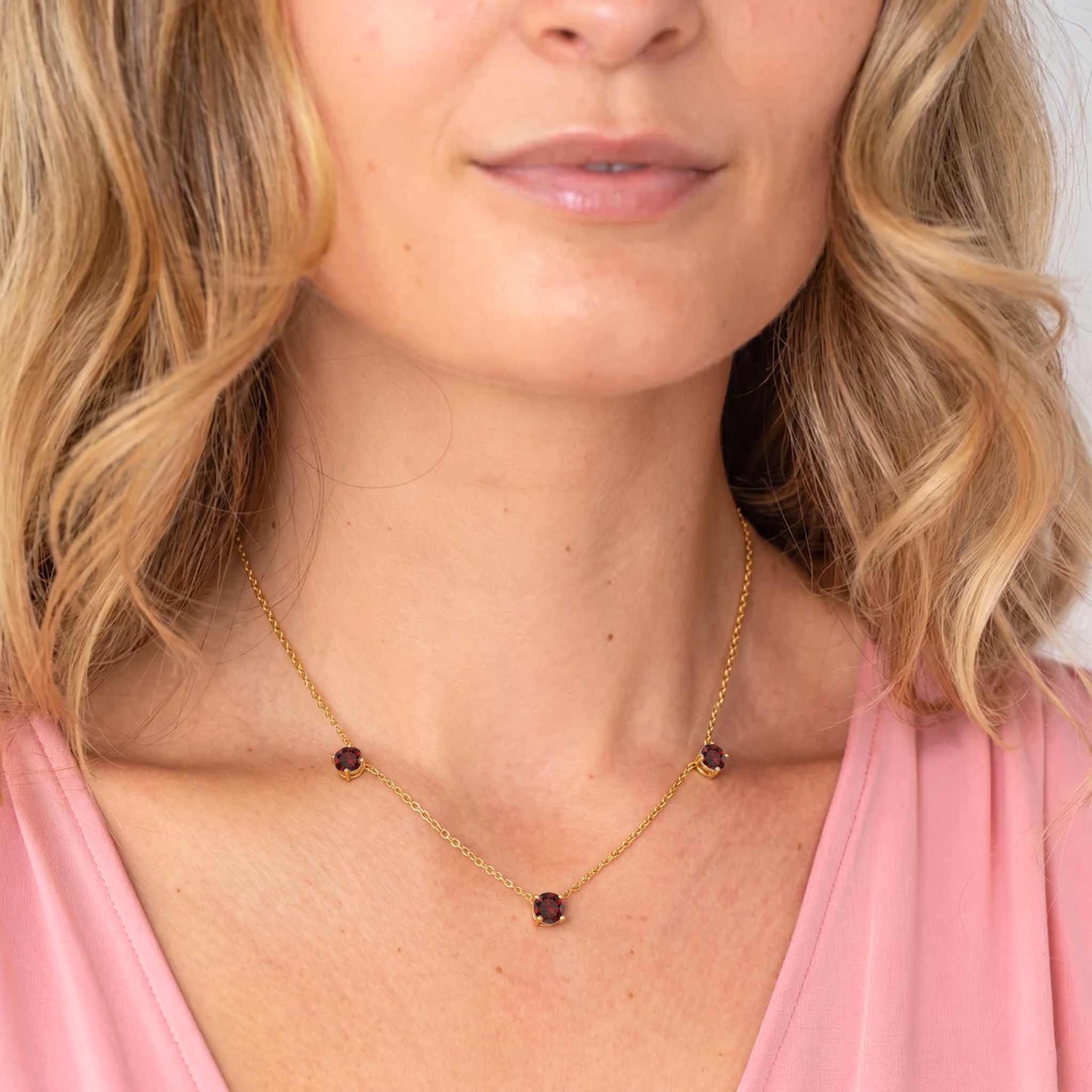 Fine jewelry Garnet necklace with a classic three stone station design.
