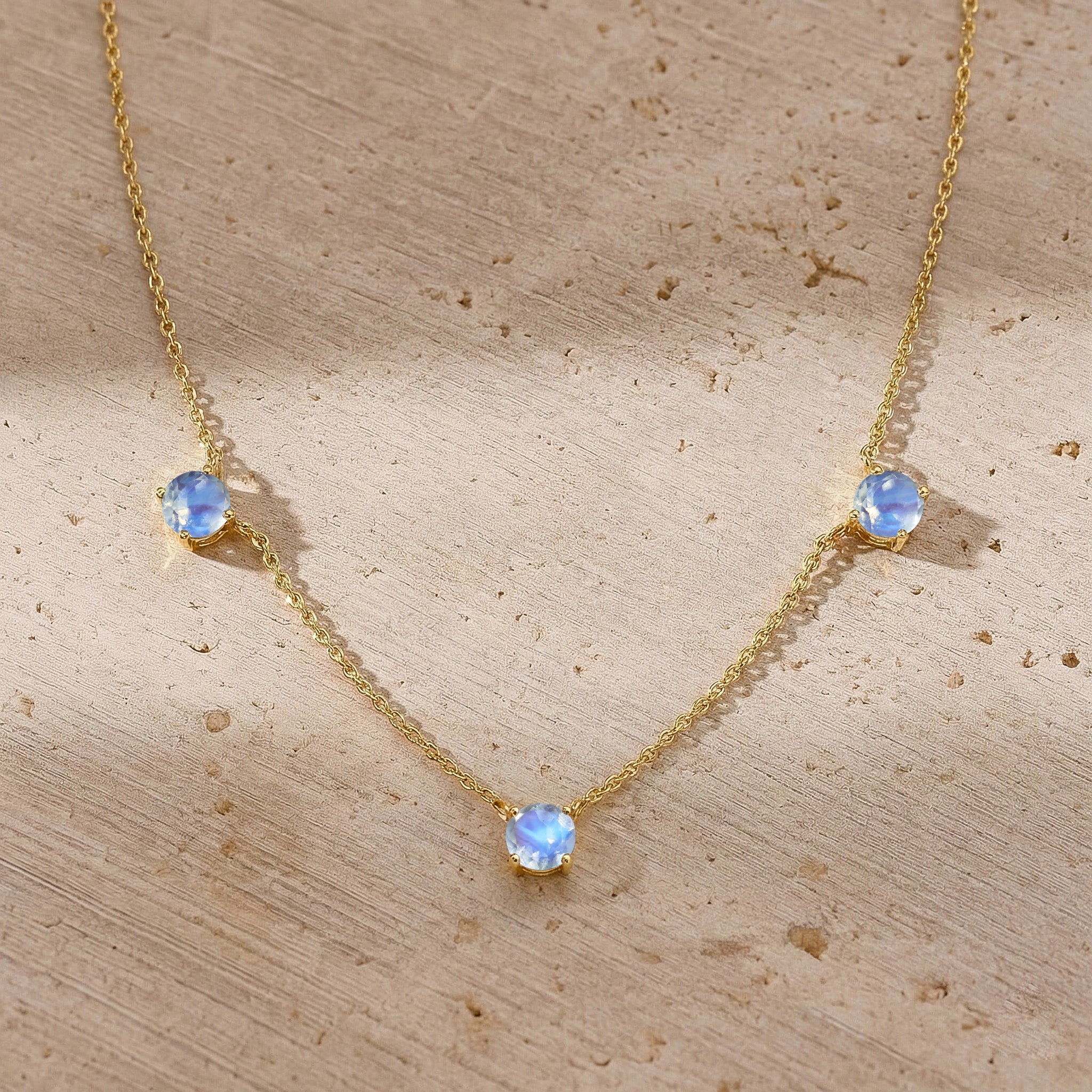 Fine jewelry Moonstone necklace with classic three stone station design.

