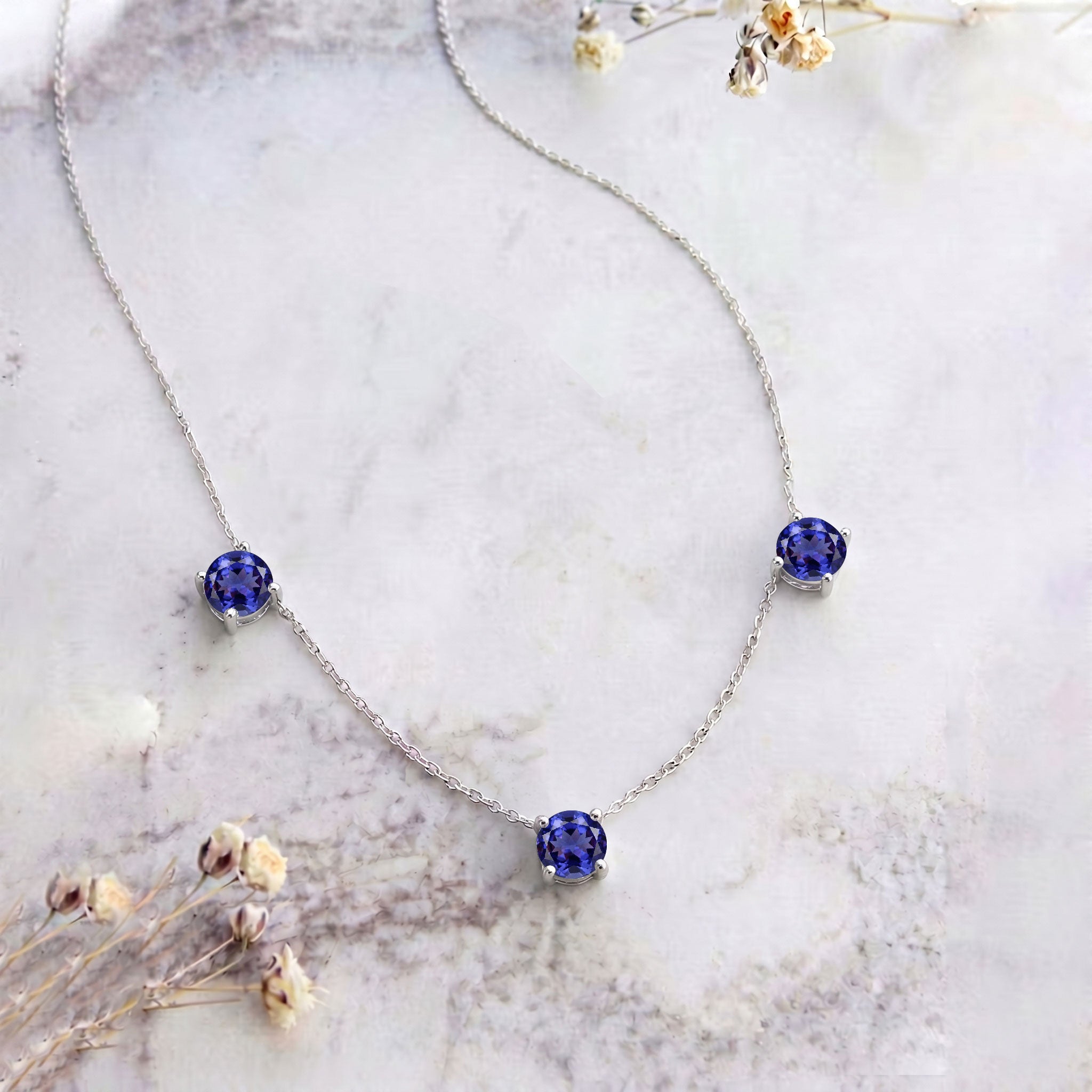 Three stone Tanzanite necklace designed with a minimalist and timeless jewelry style.
