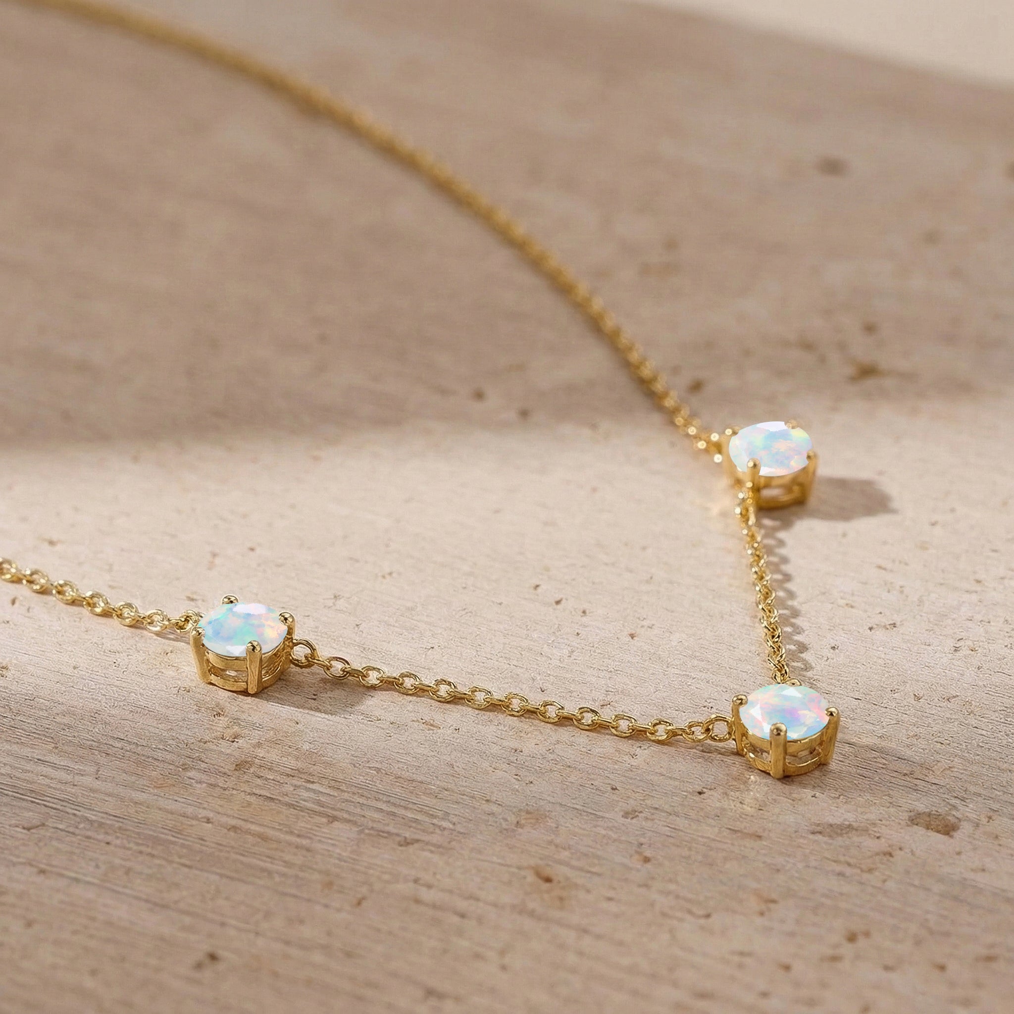 Women's fine jewelry White Opal necklace with classic station setting.
