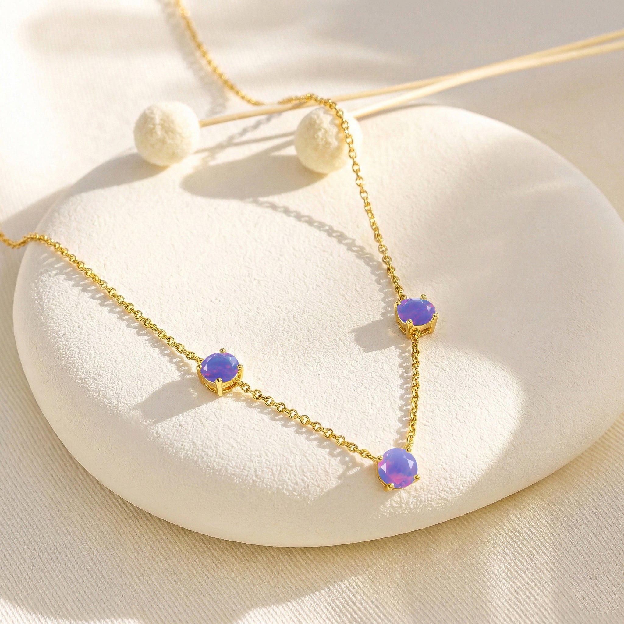 Fine jewelry Lavender Opal necklace with classic three stone station design.
