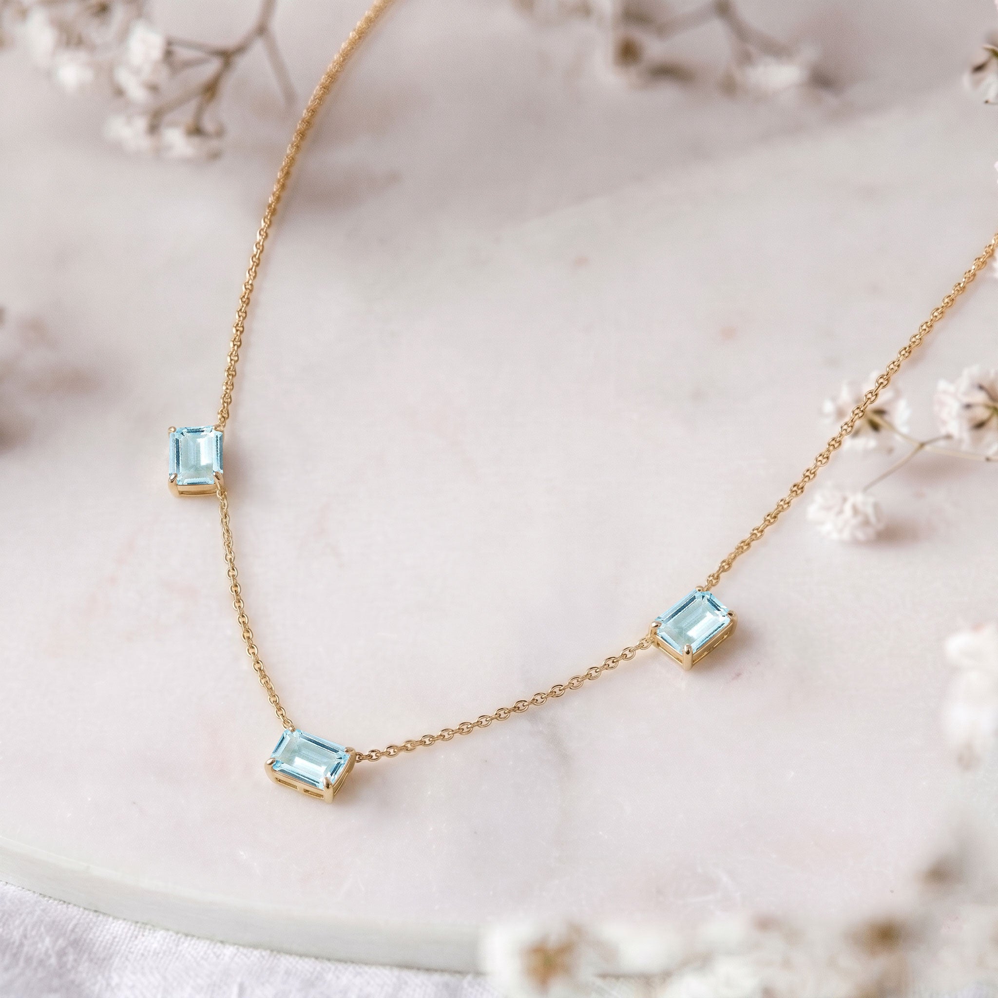Fine jewelry Aquamarine station necklace with three octagon-cut gemstones.
