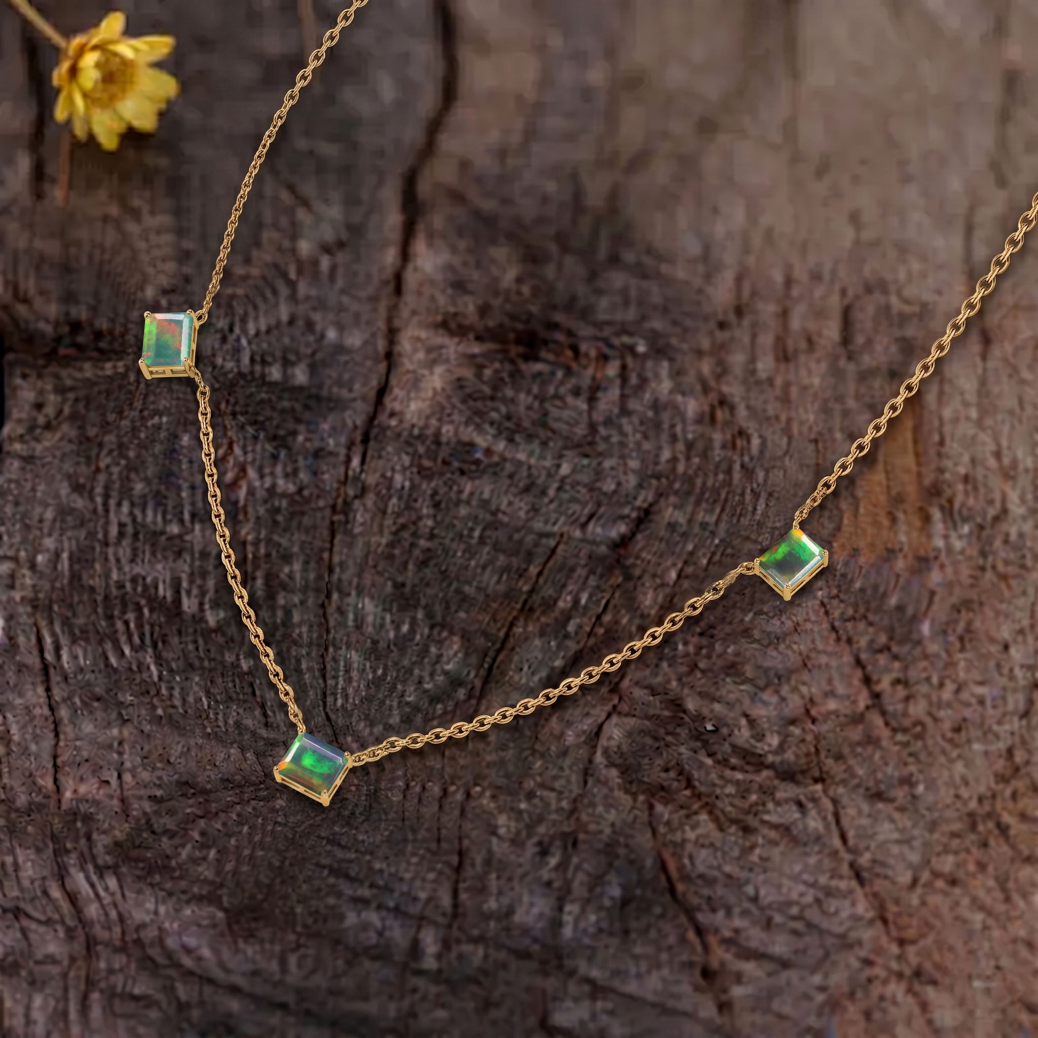Fine jewelry Black Opal station necklace with three octagon-cut gemstones.
