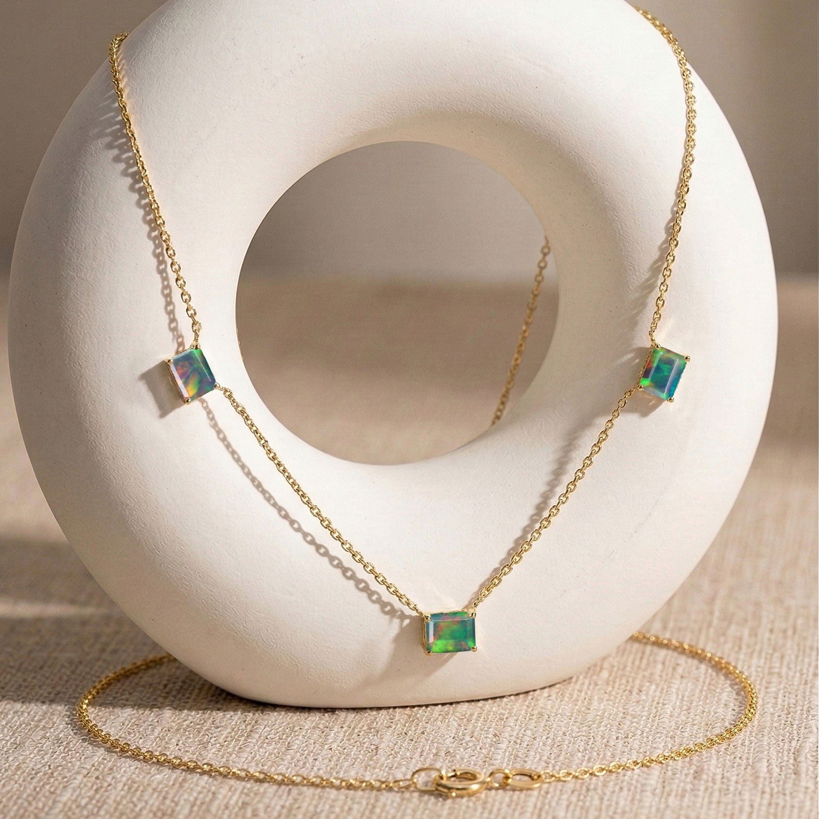 Three stone Black Opal necklace with vibrant color play.
