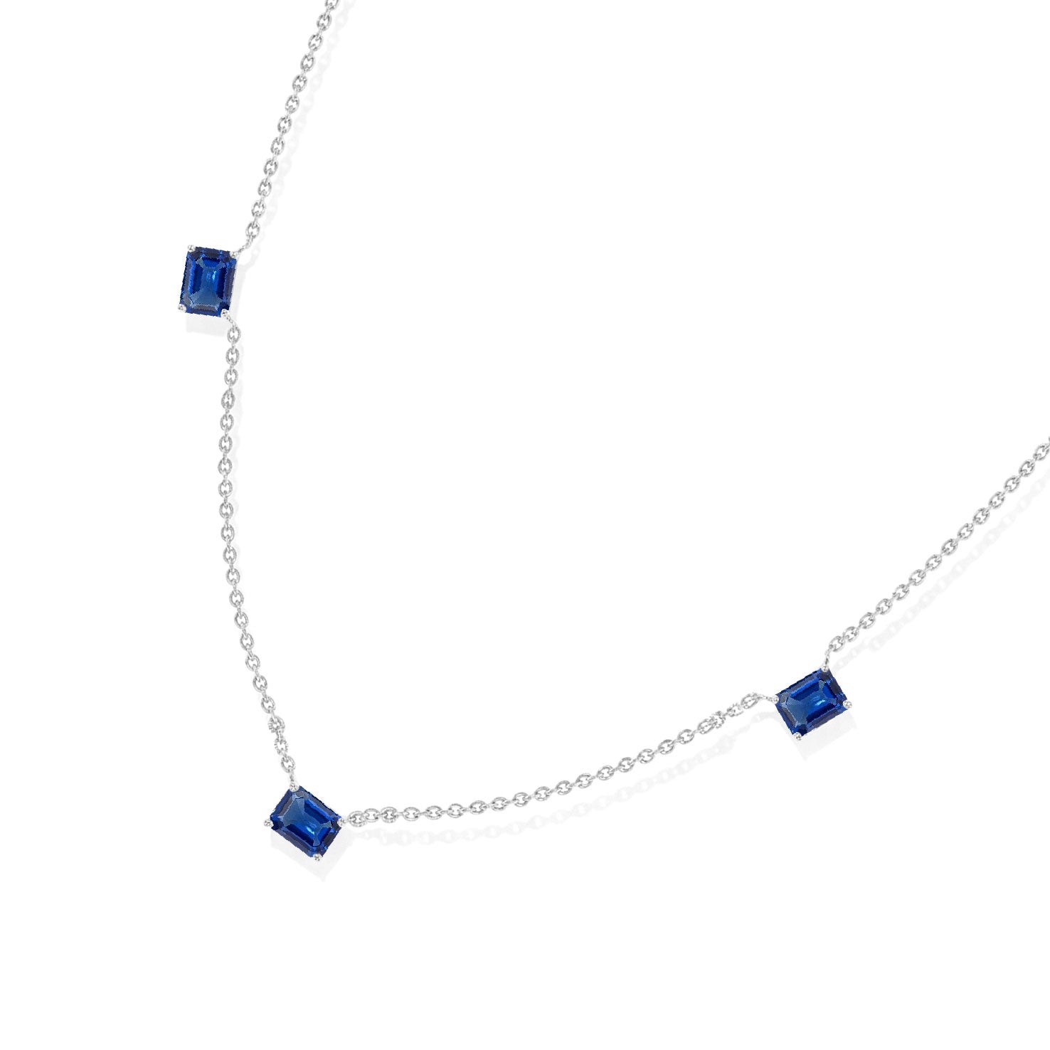 Three stone Blue Sapphire necklace featuring deep blue octagon-cut gemstones.
