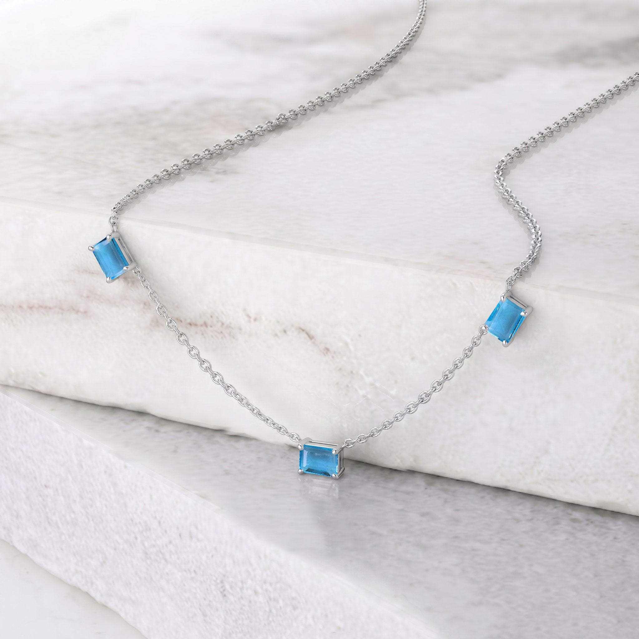 Elegant three stone Blue Topaz necklace with octagon-cut gemstones.

