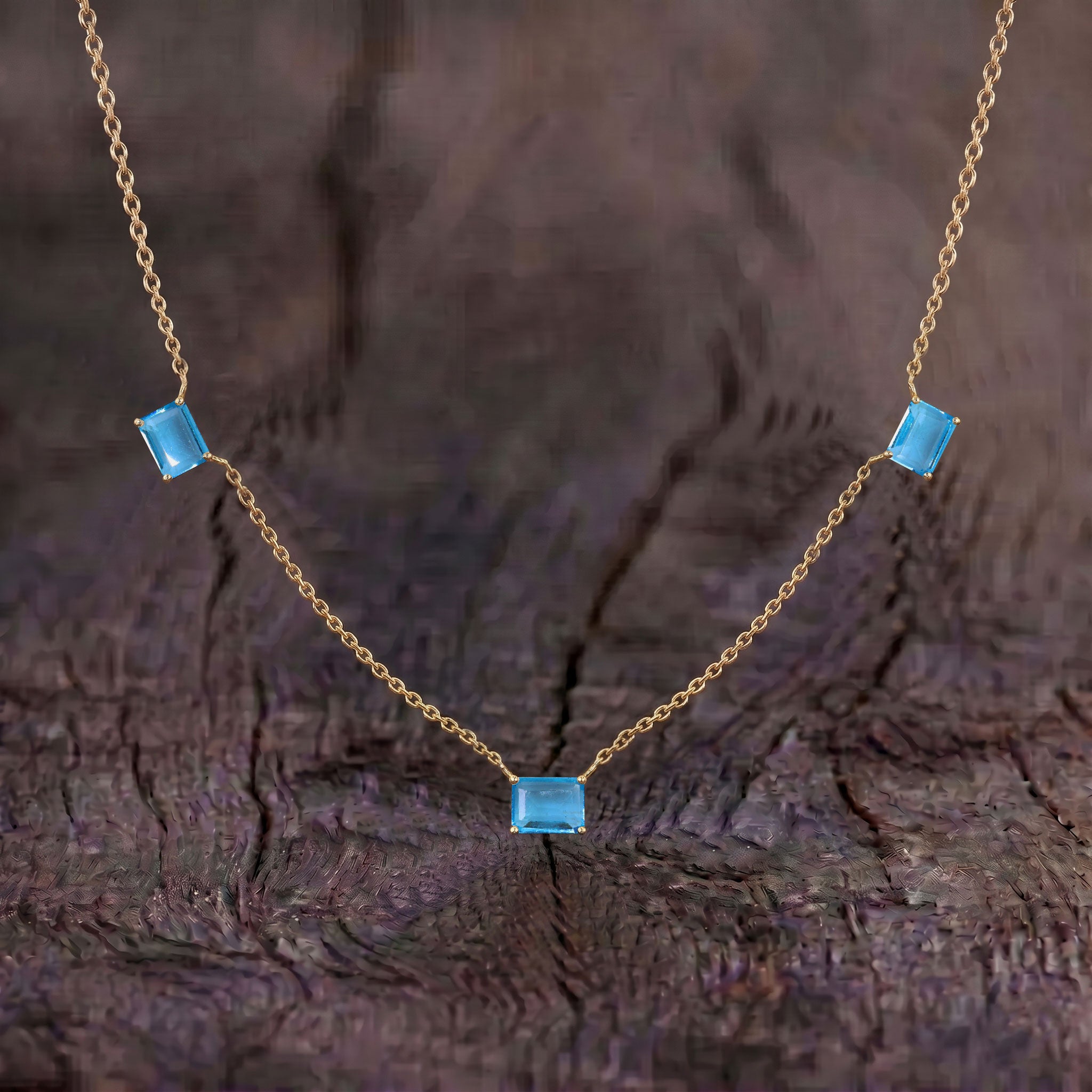 Sterling Silver Blue Topaz station necklace with genuine octagon-cut gemstones.
