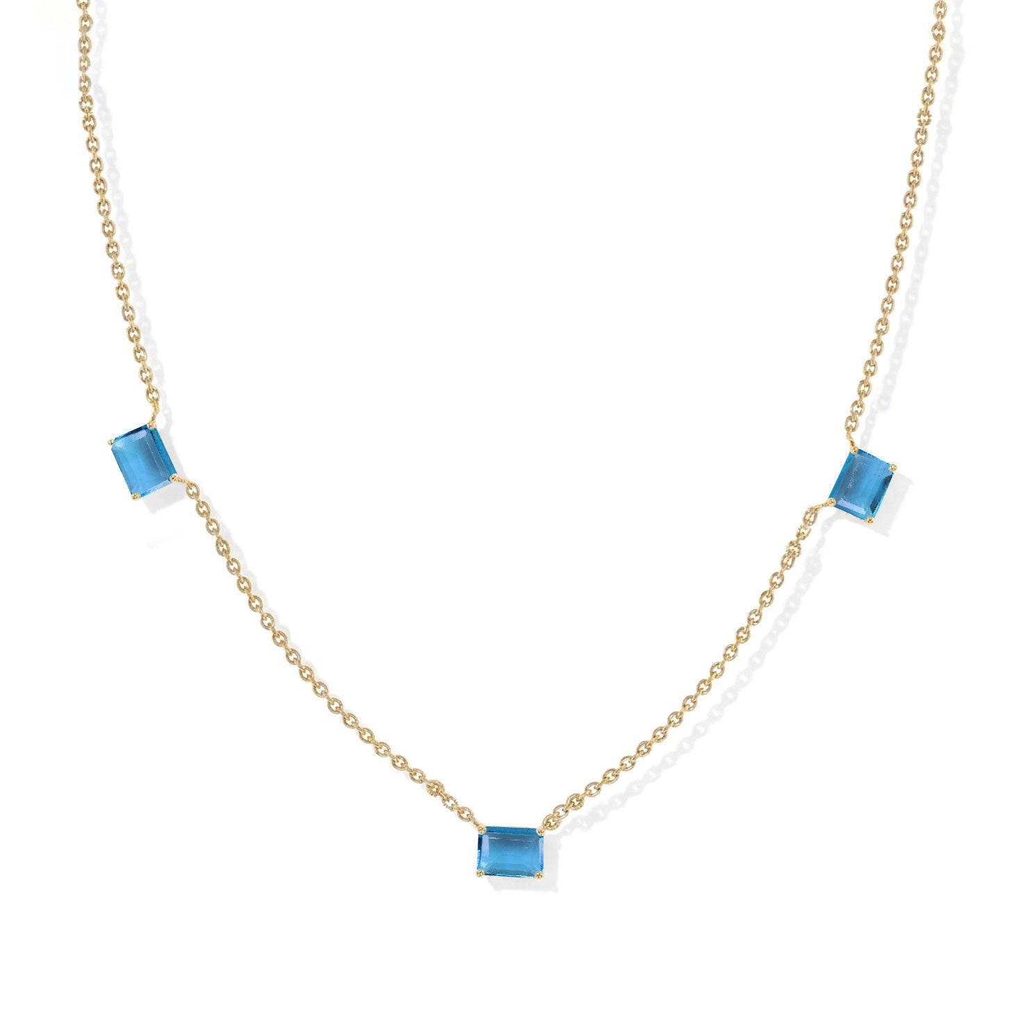 Fine jewelry Blue Topaz station necklace with three octagon-cut gemstones.
