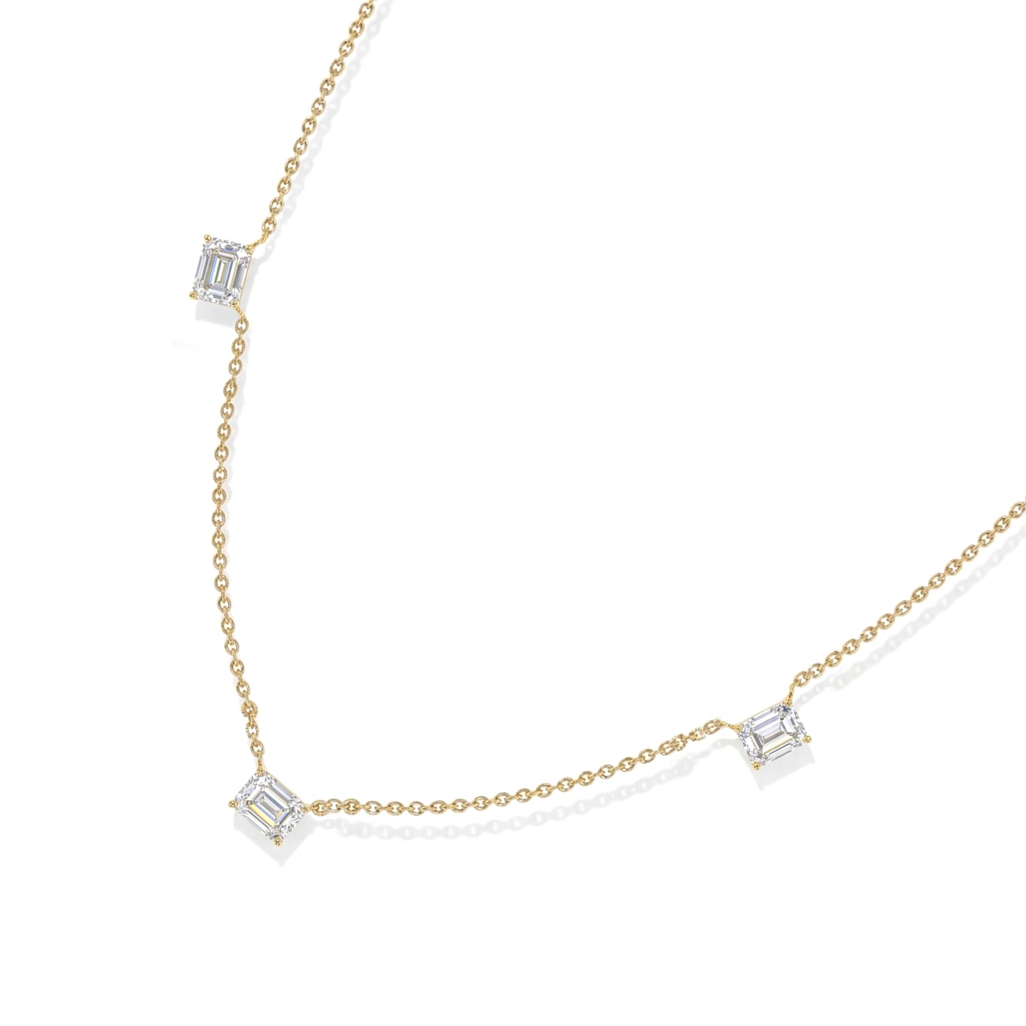 A delicate chain necklace featuring three small rectangular baguette-cut clear gemstones spaced along the chain, displayed on a clean white background.