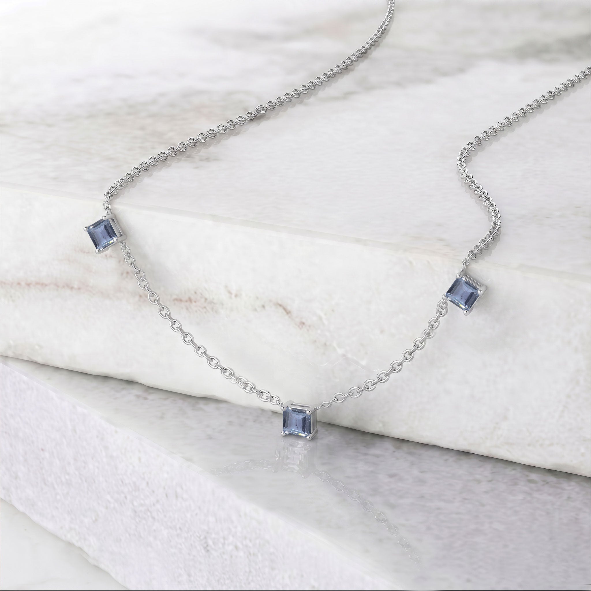 Minimalist Alexandrite necklace featuring three Asscher cut color changing gemstones.
