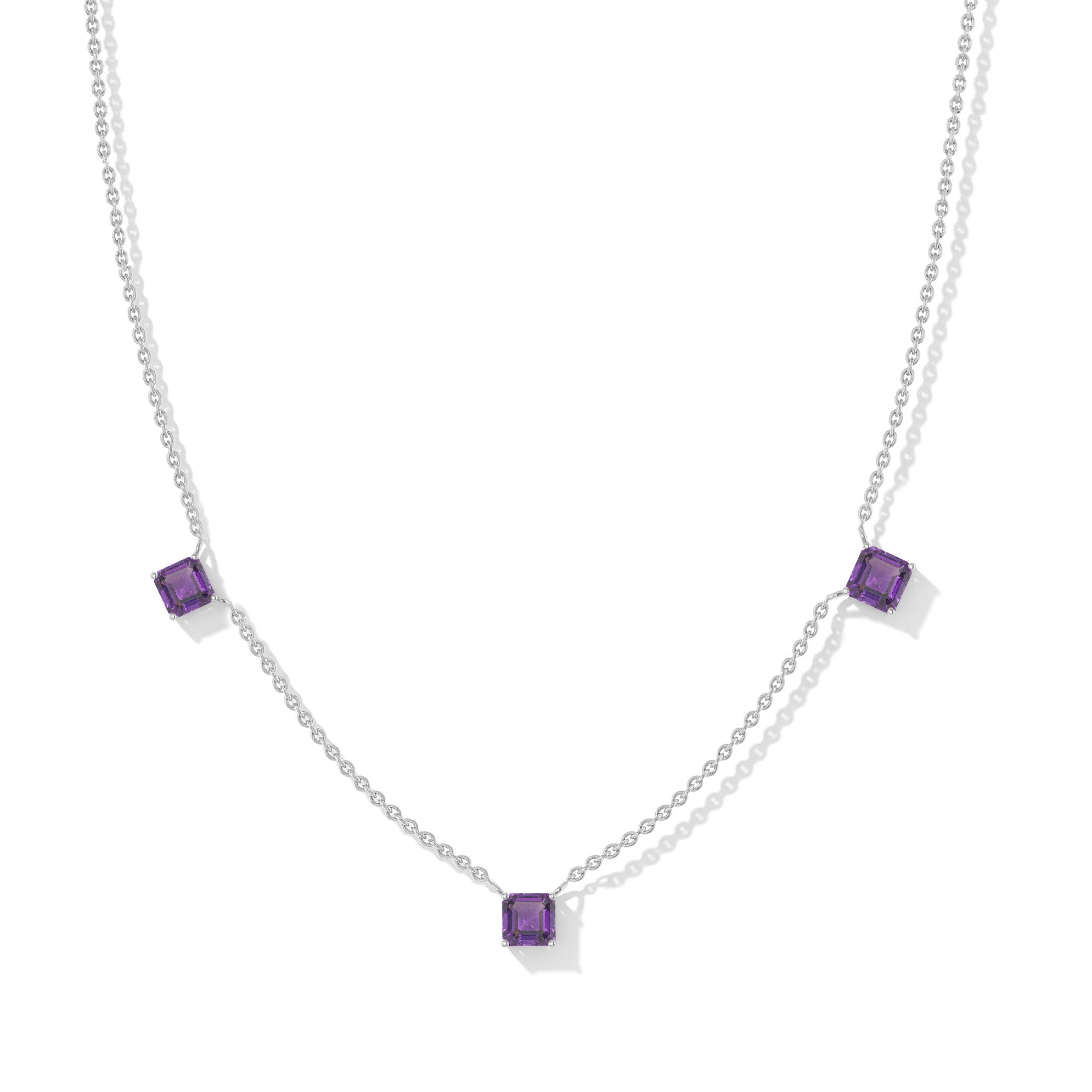 "Amethyst Asscher cut station necklace in yellow gold filled and 925 sterling silver featuring three purple gemstones.
