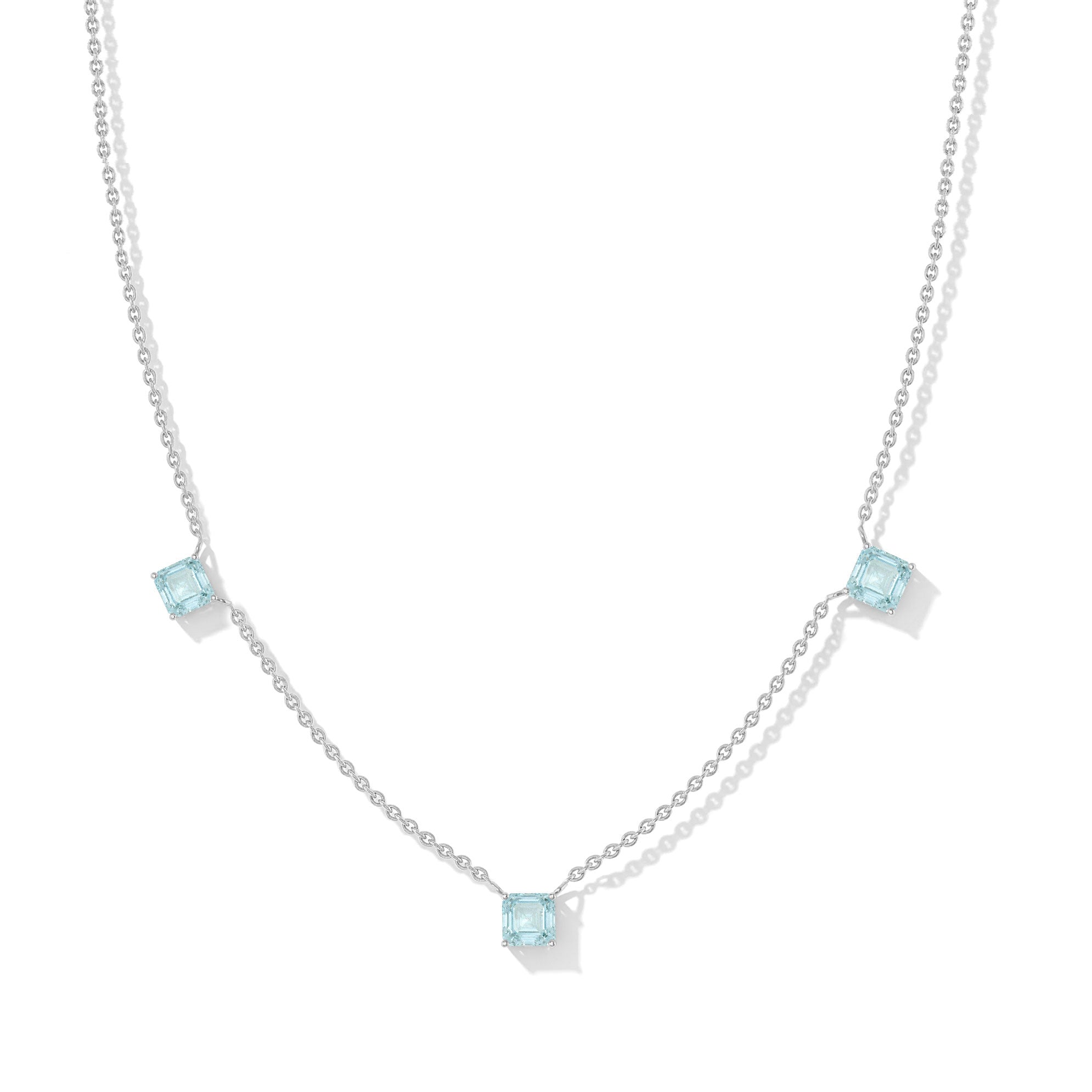 "Elegant Aquamarine Asscher cut necklace featuring three blue gemstones in sterling silver.
