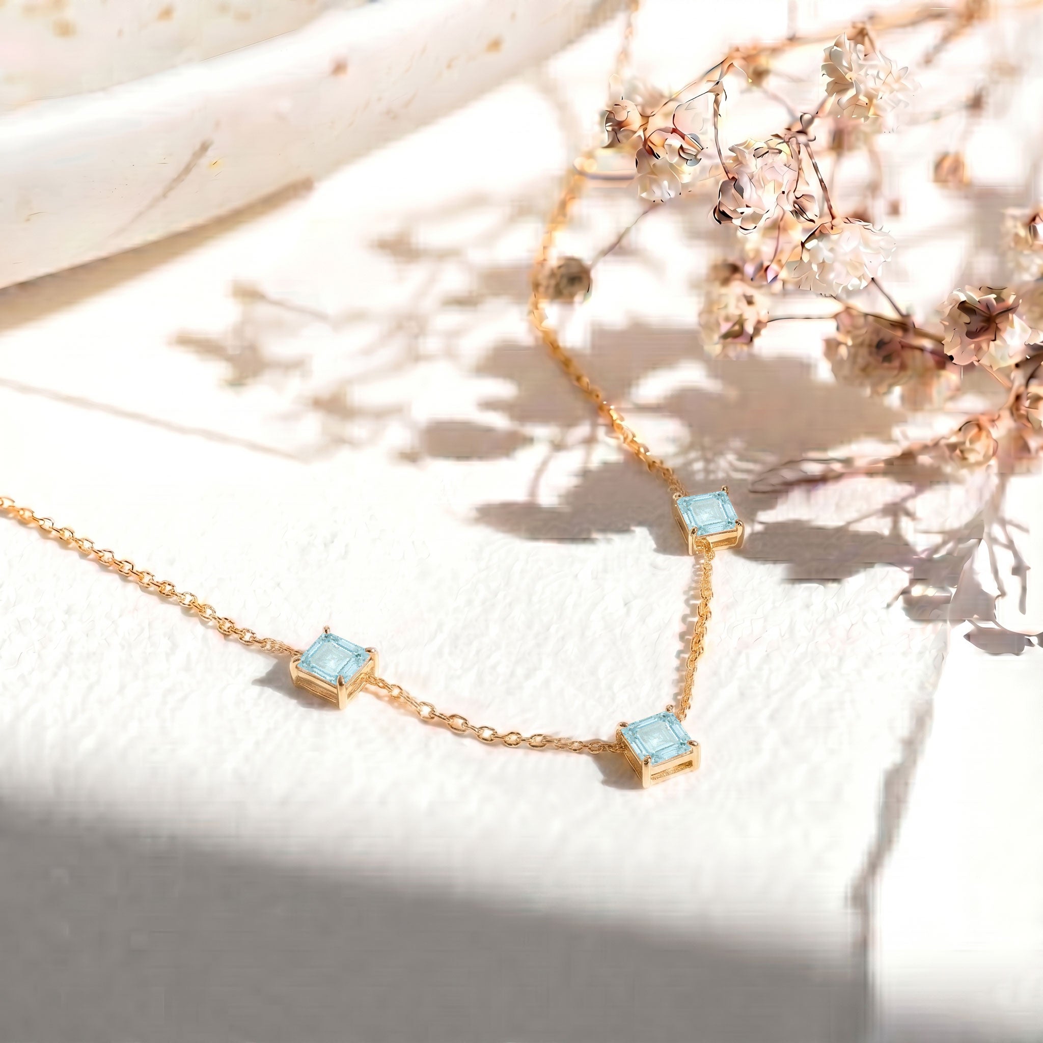 Women's Aquamarine gemstone necklace with elegant Asscher cut design.
