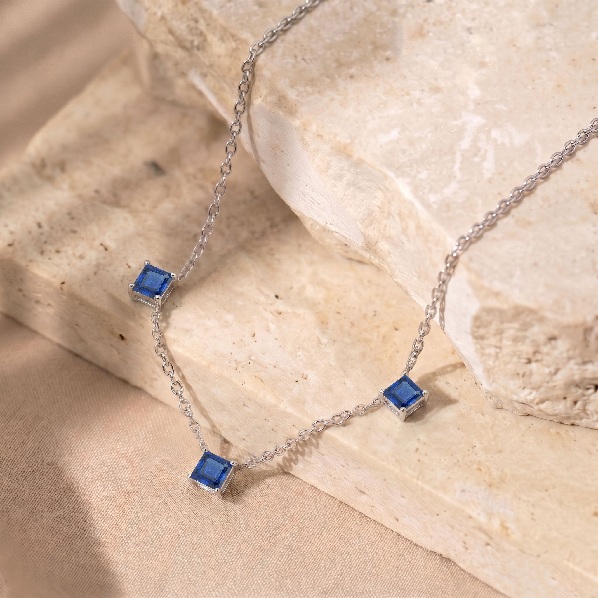 Three stone Blue Sapphire necklace crafted in 925 sterling silver.
