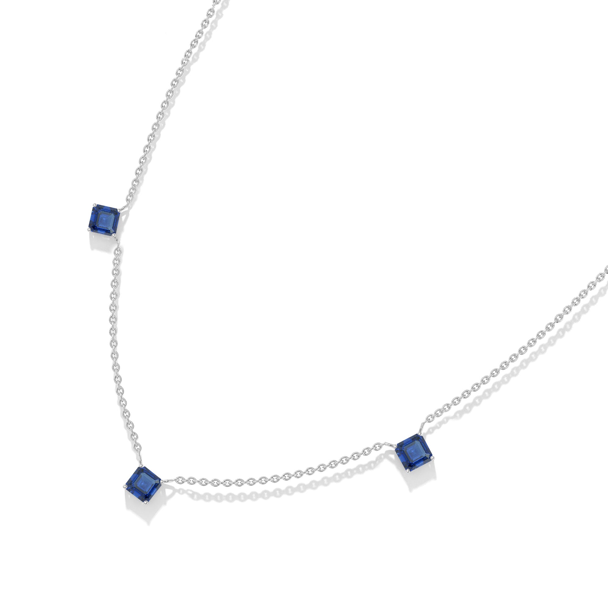 Luxury Blue Sapphire gemstone necklace featuring three Asscher cut stones.
