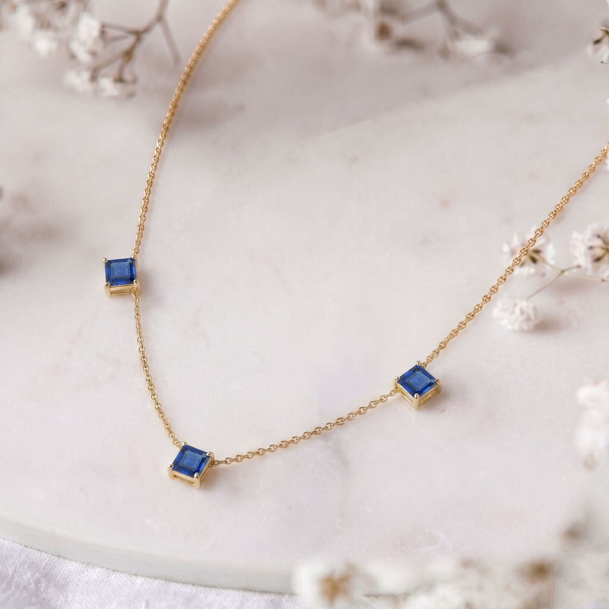 Fine jewelry Blue Sapphire station necklace in sterling silver and yellow gold filled.
