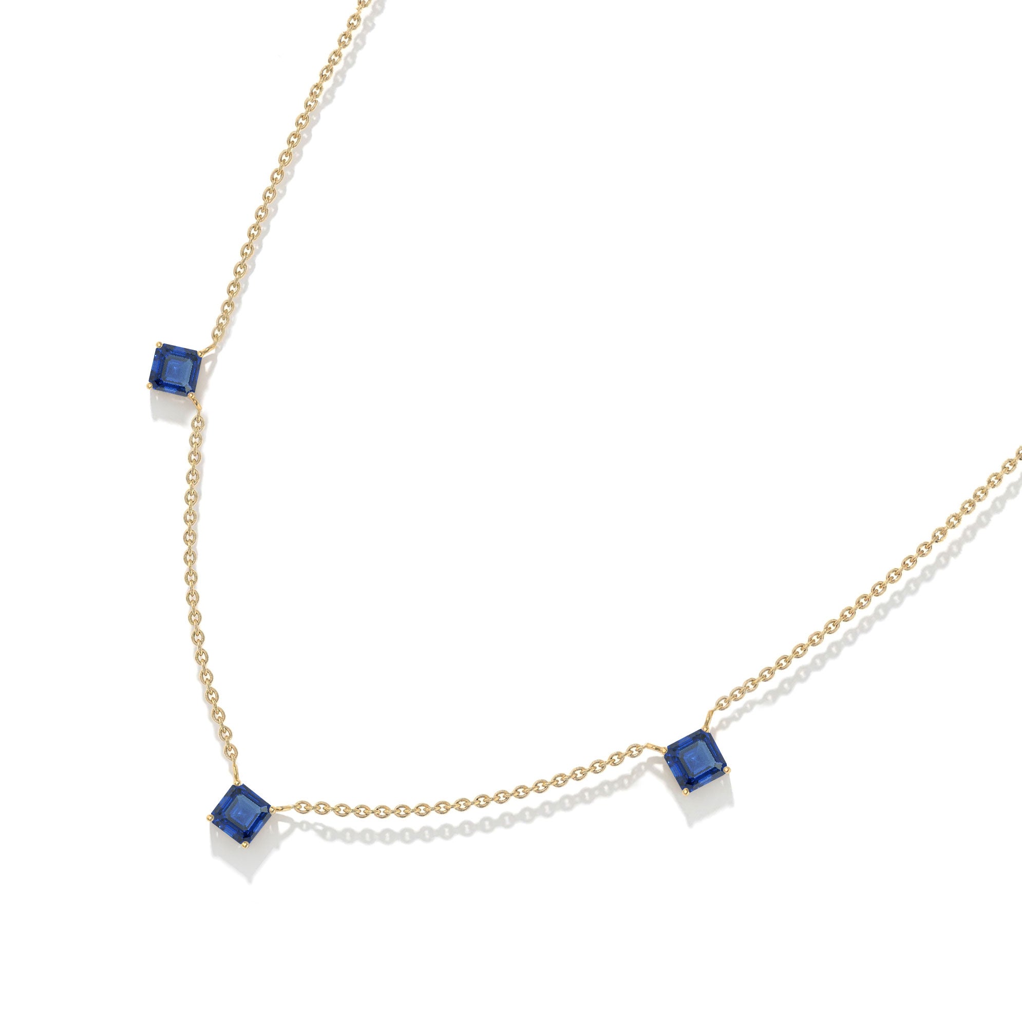 Contemporary Blue Sapphire station necklace with a minimalist three stone design.
