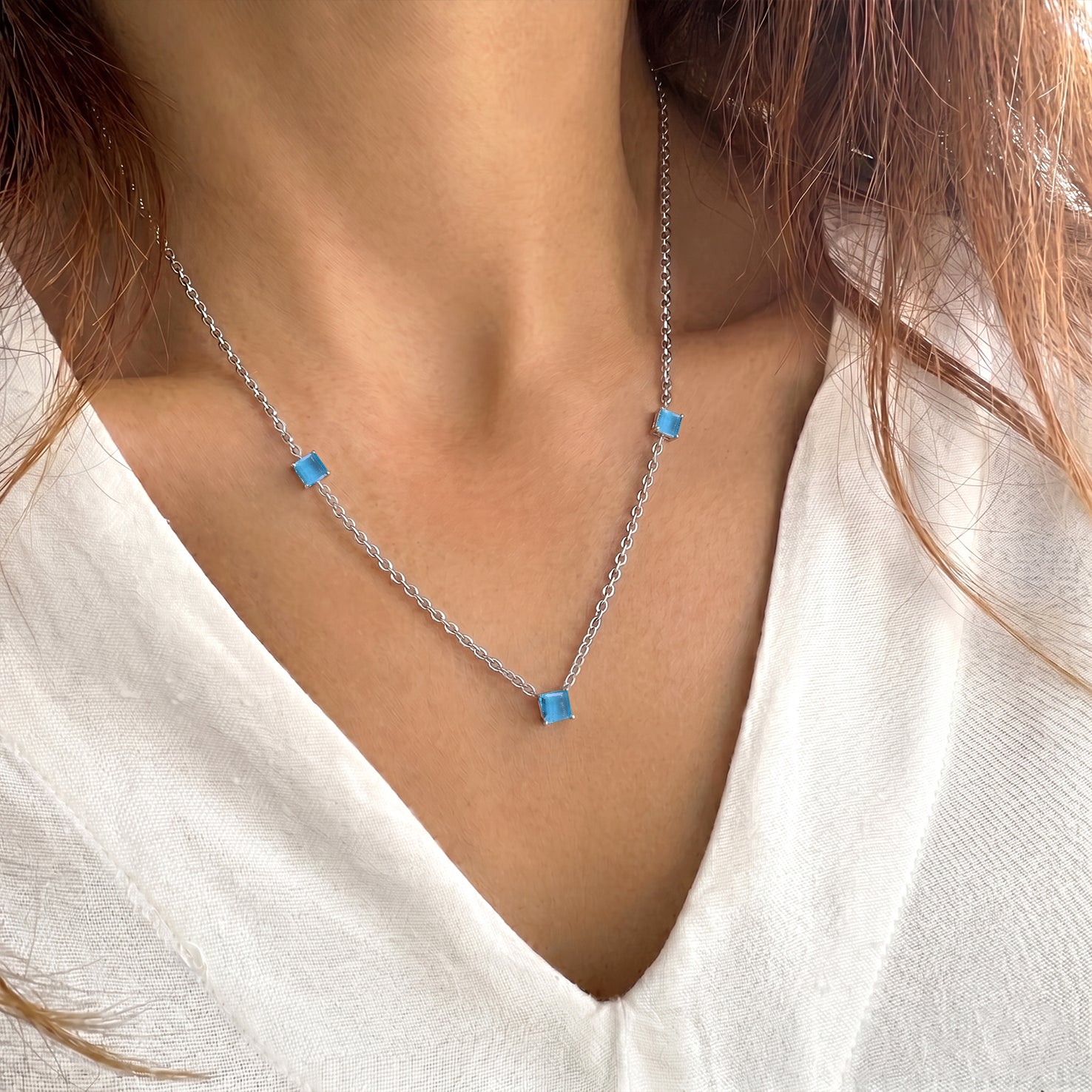 	Adjustable Blue Topaz necklace with polished sterling silver chain.
