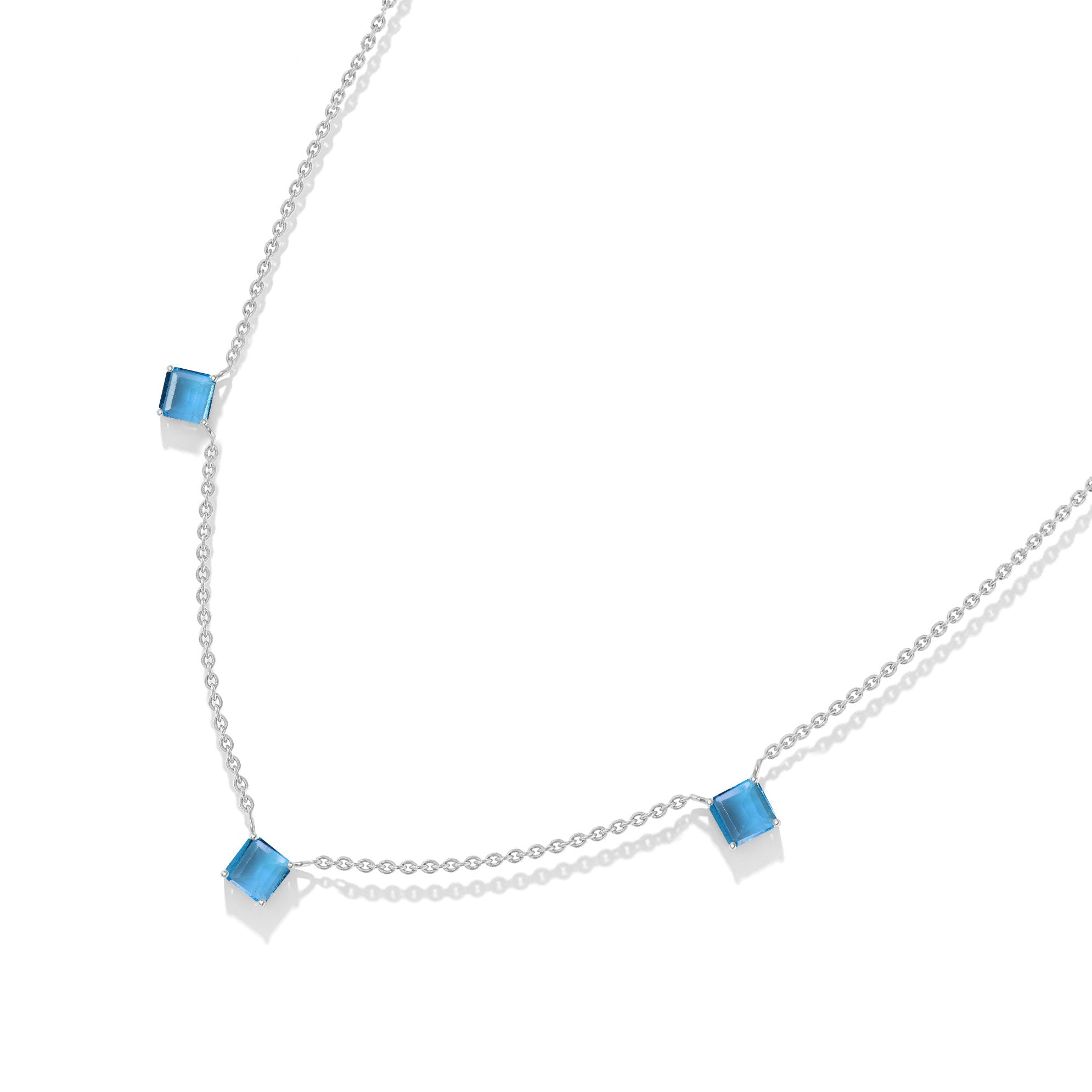 Contemporary Blue Topaz station necklace with a minimalist three stone design.
