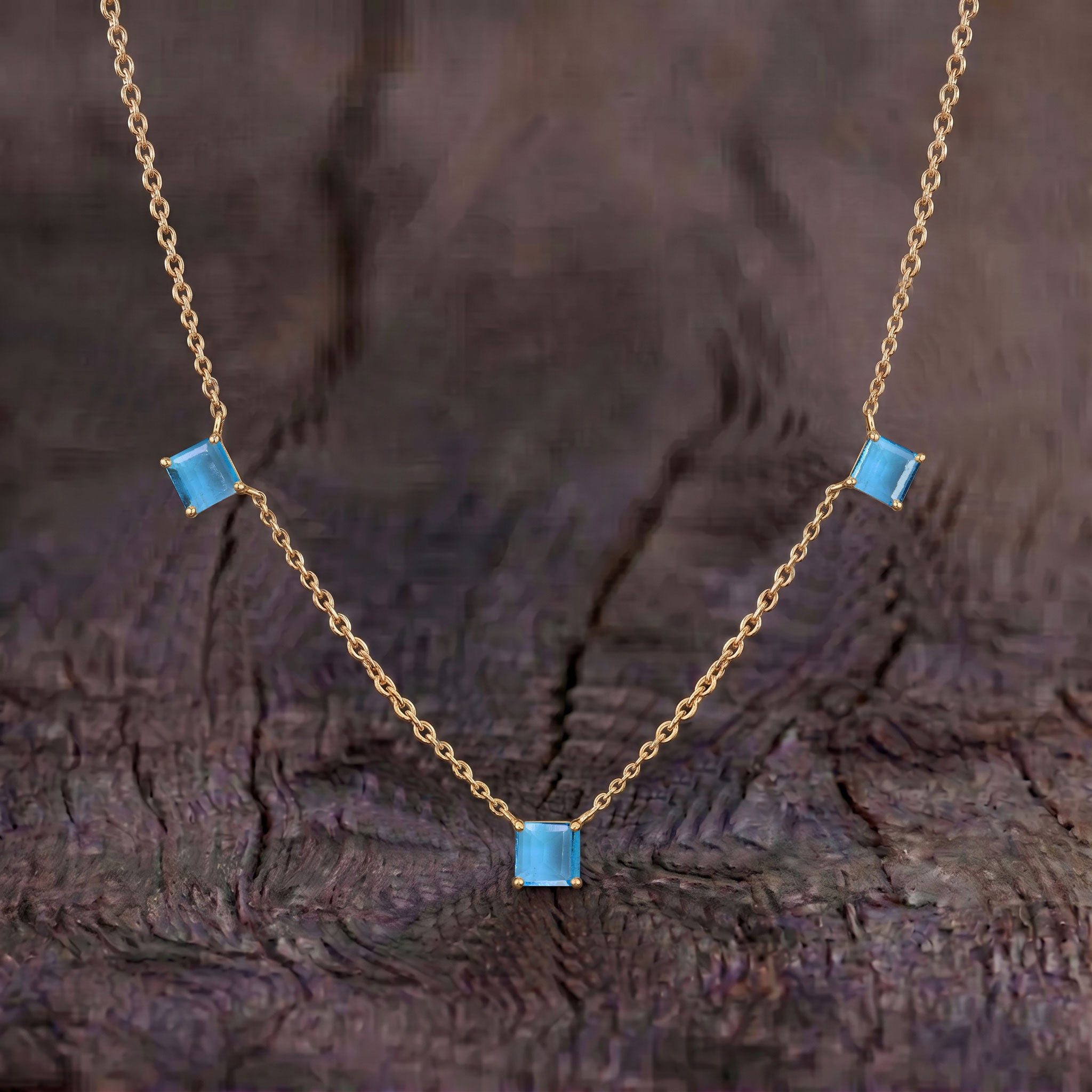 Fine jewelry Blue Topaz station necklace in sterling silver and yellow gold filled.
