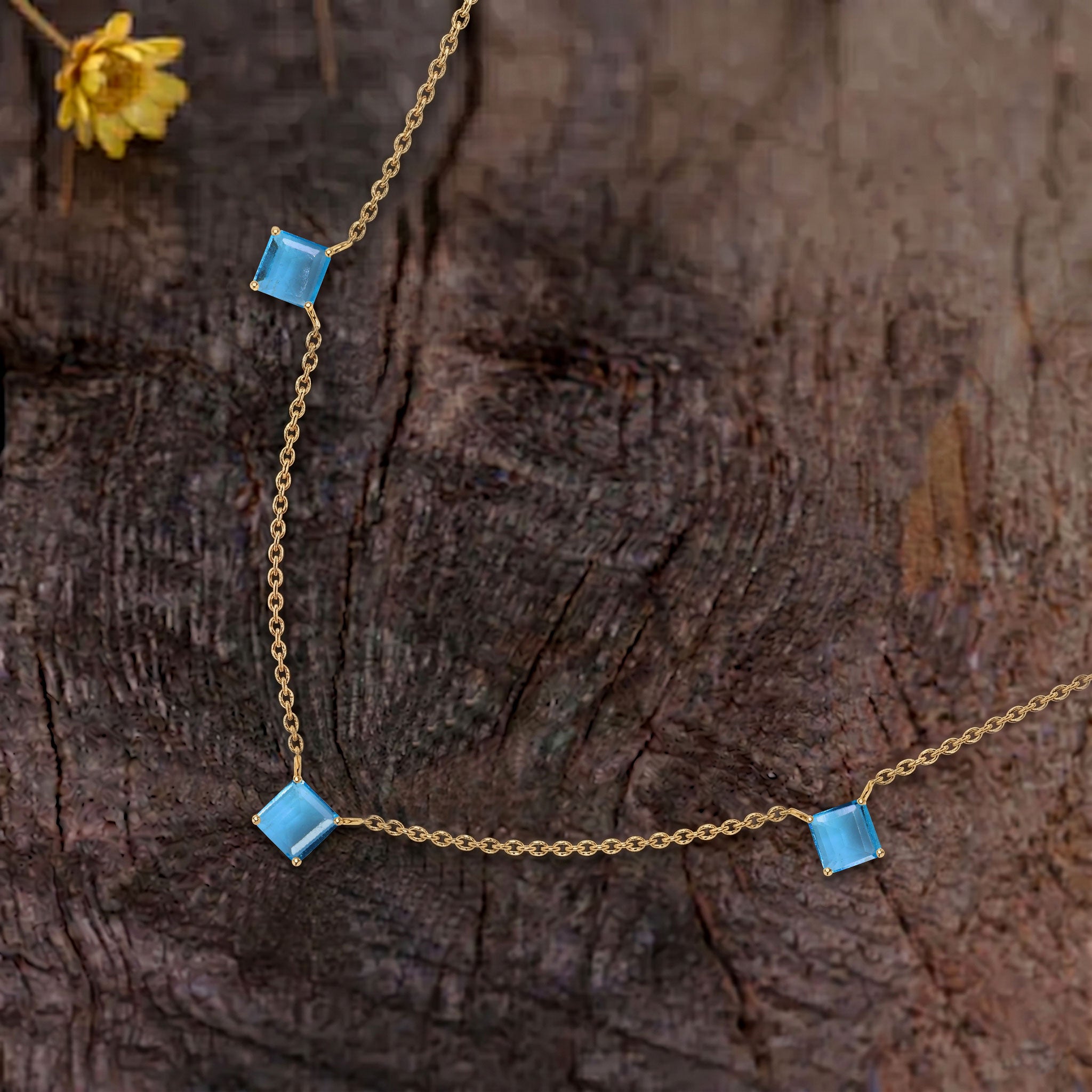Handmade Blue Topaz necklace showcasing premium Asscher cut gemstones.
