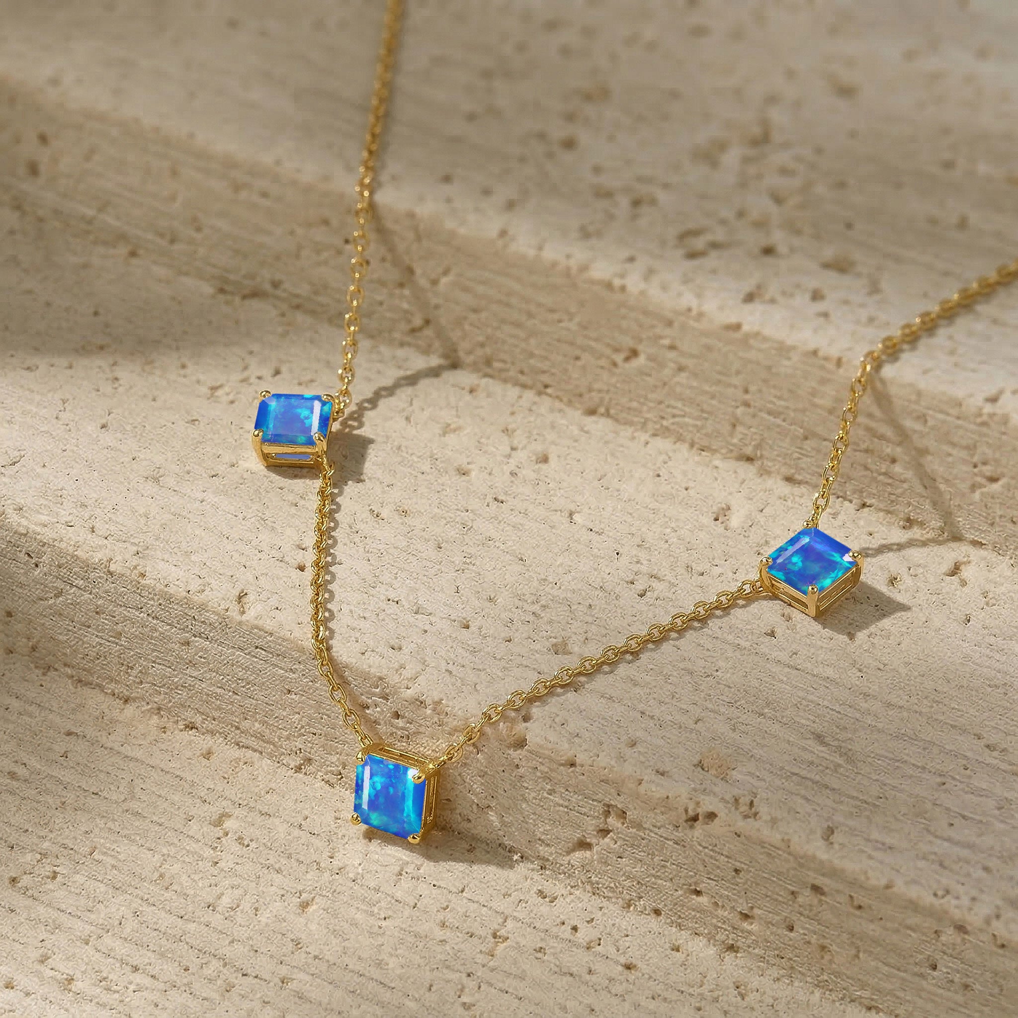 Luxury Natural Blue Opal gemstone necklace featuring three Asscher cut stones.
