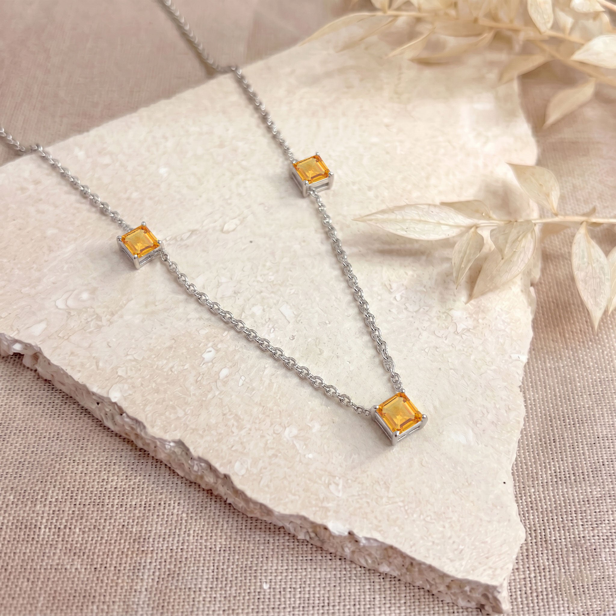Sterling silver Citrine necklace featuring brilliant Asscher cut gemstone stations.
