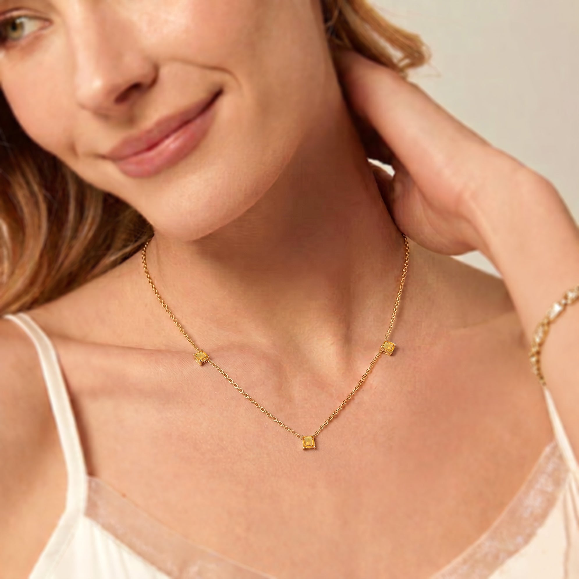 Fine jewelry Citrine necklace with three golden gemstones on a delicate chain.
