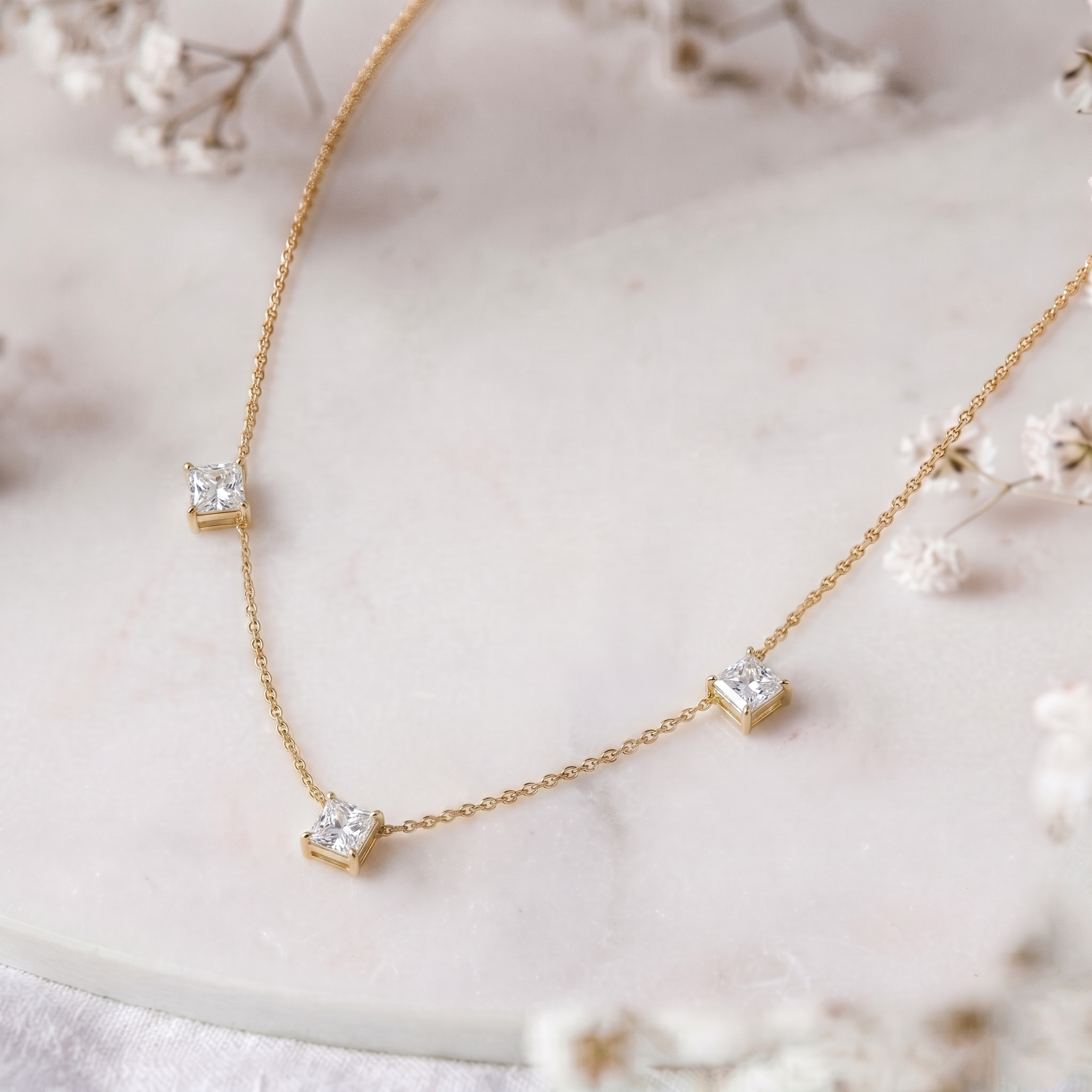 Dainty three stone Moissanite necklace with brilliant Asscher cut gemstones and yellow gold filled sterling silver chain.
