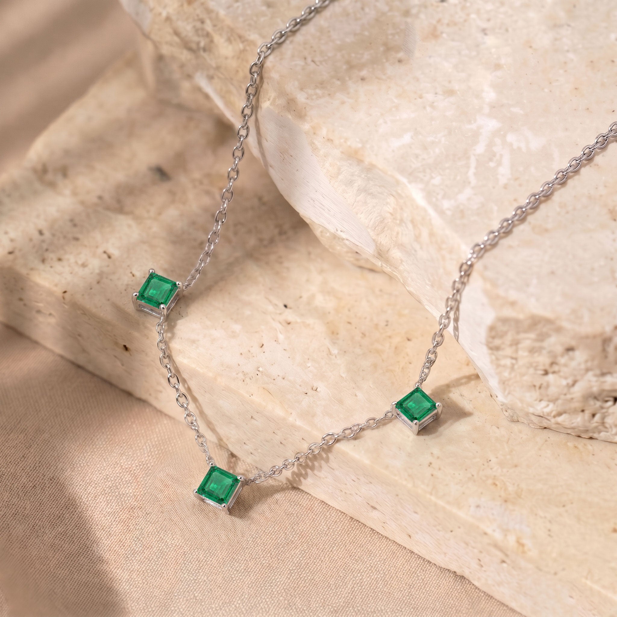 Three stone Emerald necklace crafted in 925 sterling silver for women.
