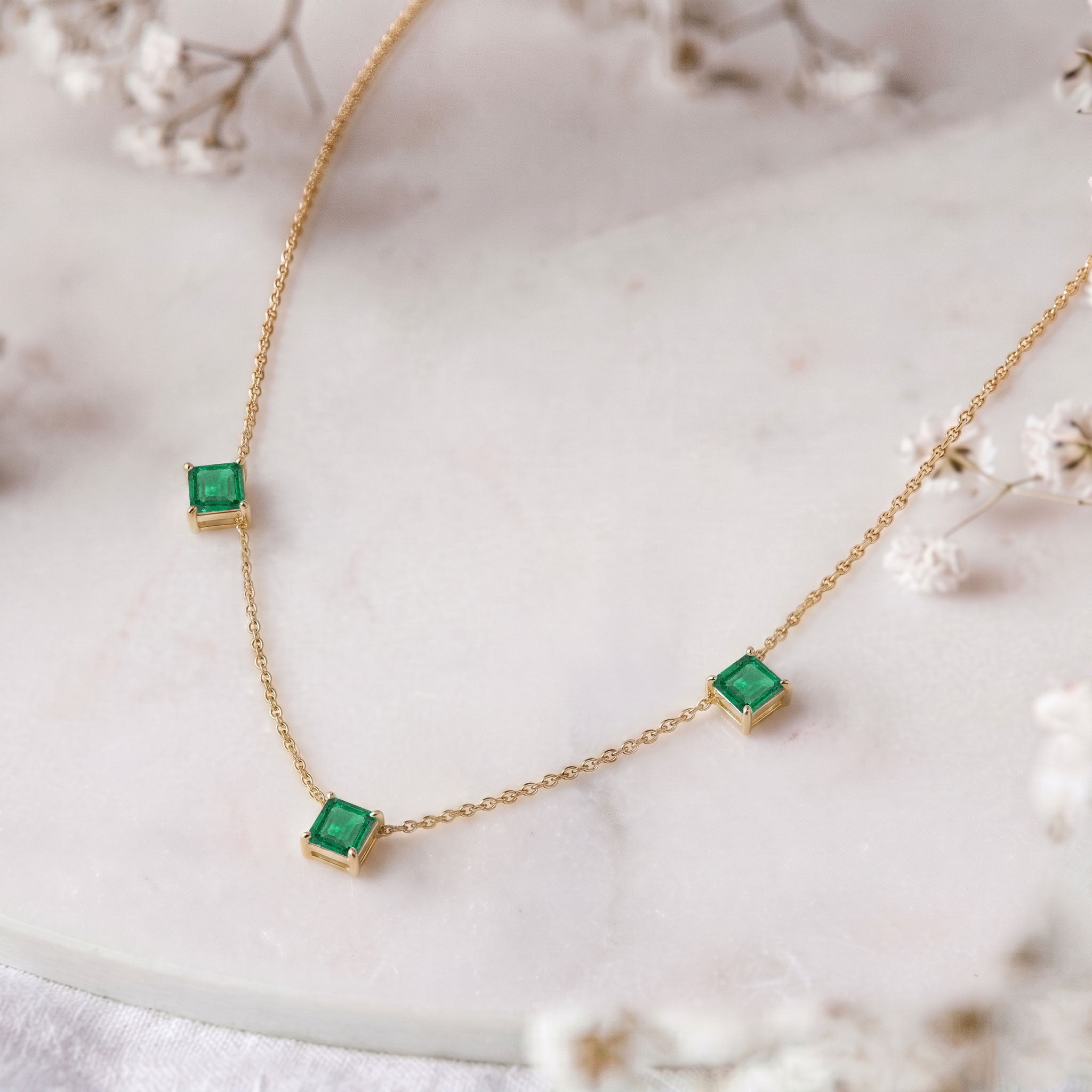 Modern Emerald station necklace designed for layering and everyday elegance.
