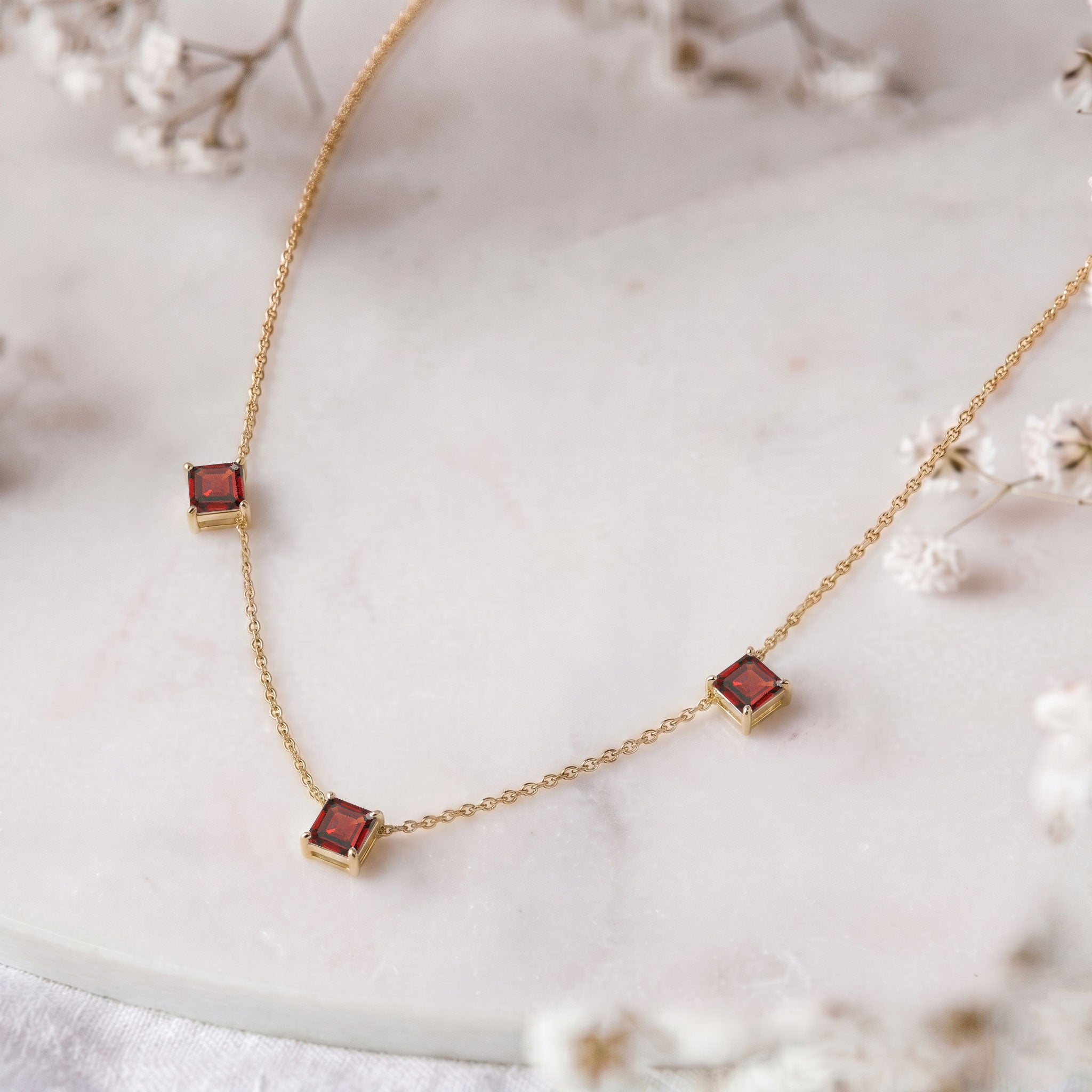 Handmade Garnet necklace showcasing premium Asscher cut gemstones.
