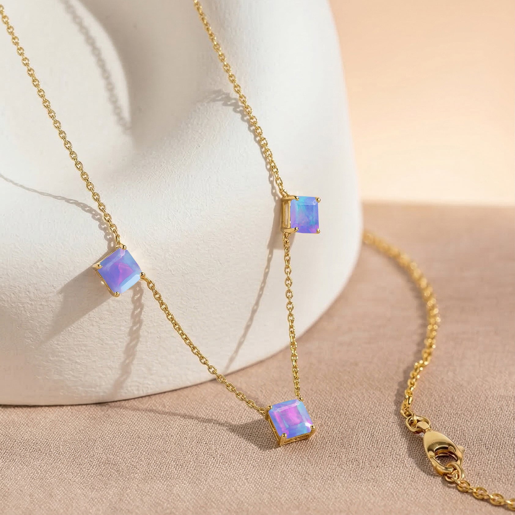 Fine jewelry Lavender Opal necklace with adjustable chain, genuine 925 sterling silver, yellow gold filled finish, and modern three stone design.
