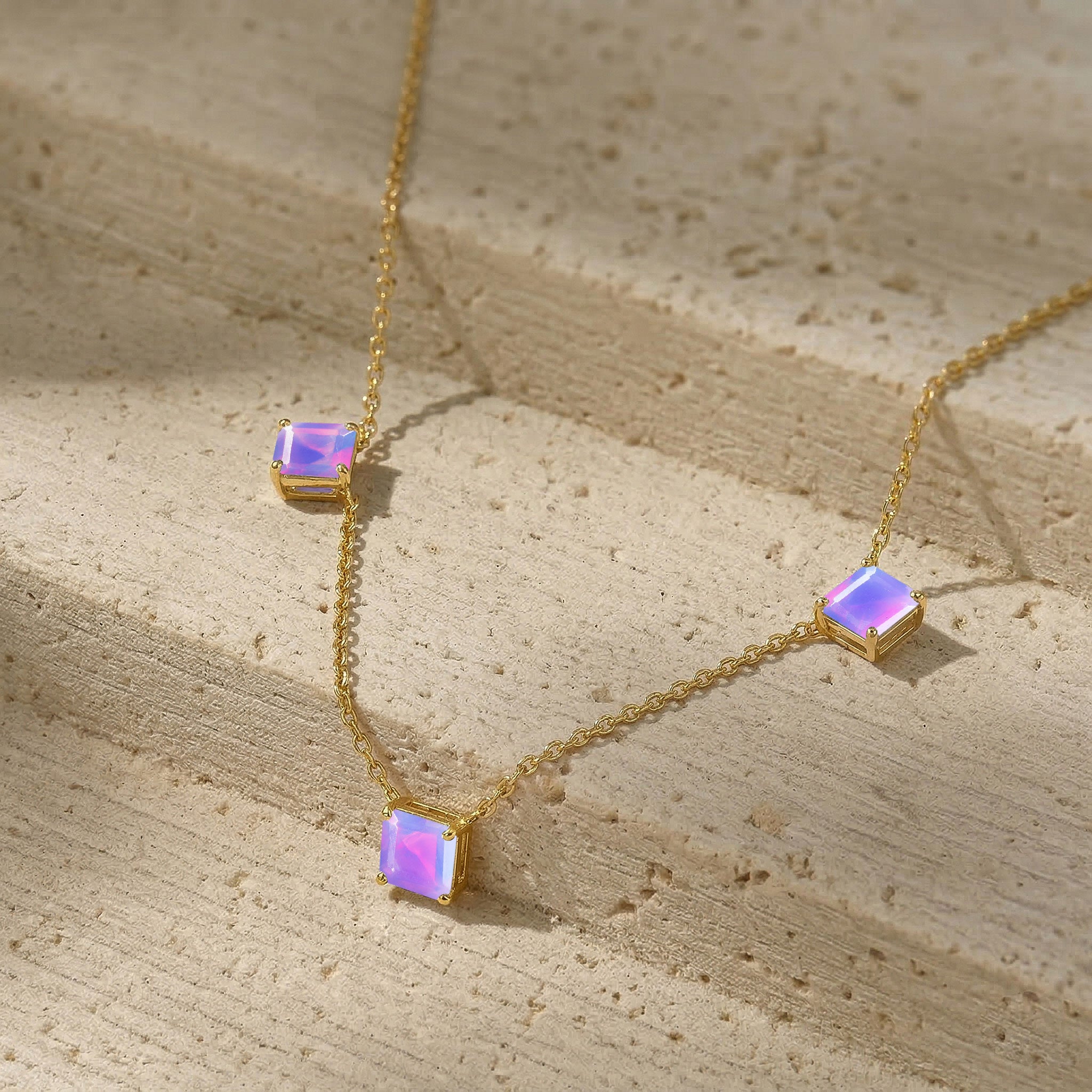 Adjustable Lavender Opal necklace featuring three 5mm Asscher cut gemstones totaling approximately 1.95 carats in sterling silver.
