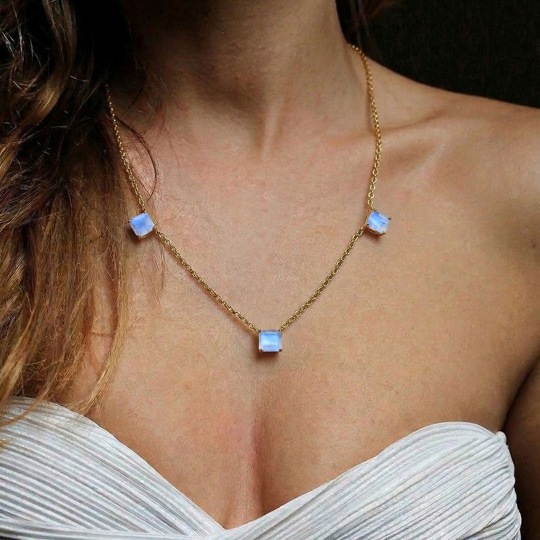 Luxury Moonstone jewelry featuring three sparkling Asscher cut gemstones.
