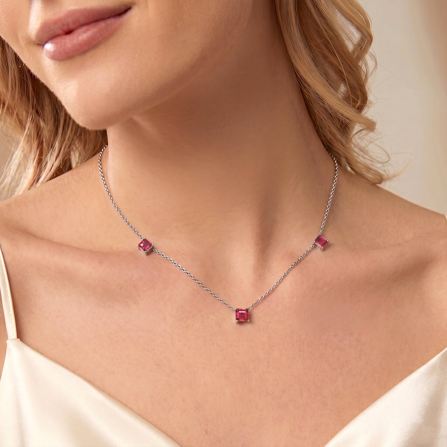 	Elegant October birthstone Pink Tourmaline necklace featuring three 5mm Asscher cut stones in sterling silver jewelry.
