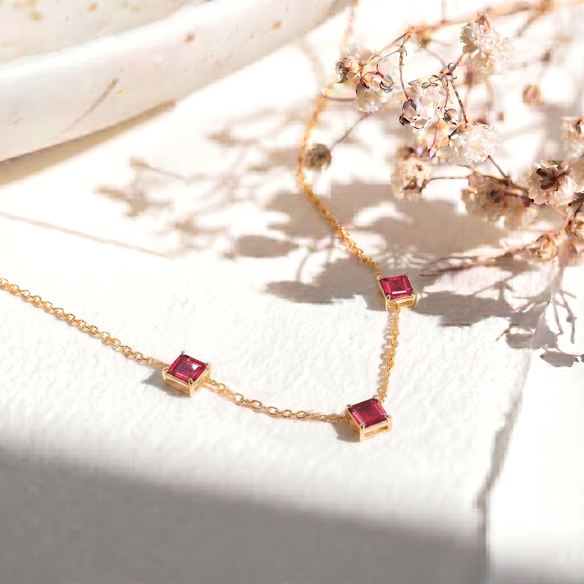 Dainty Pink Tourmaline gemstone necklace with three Asscher cut stones and yellow gold filled finish.
