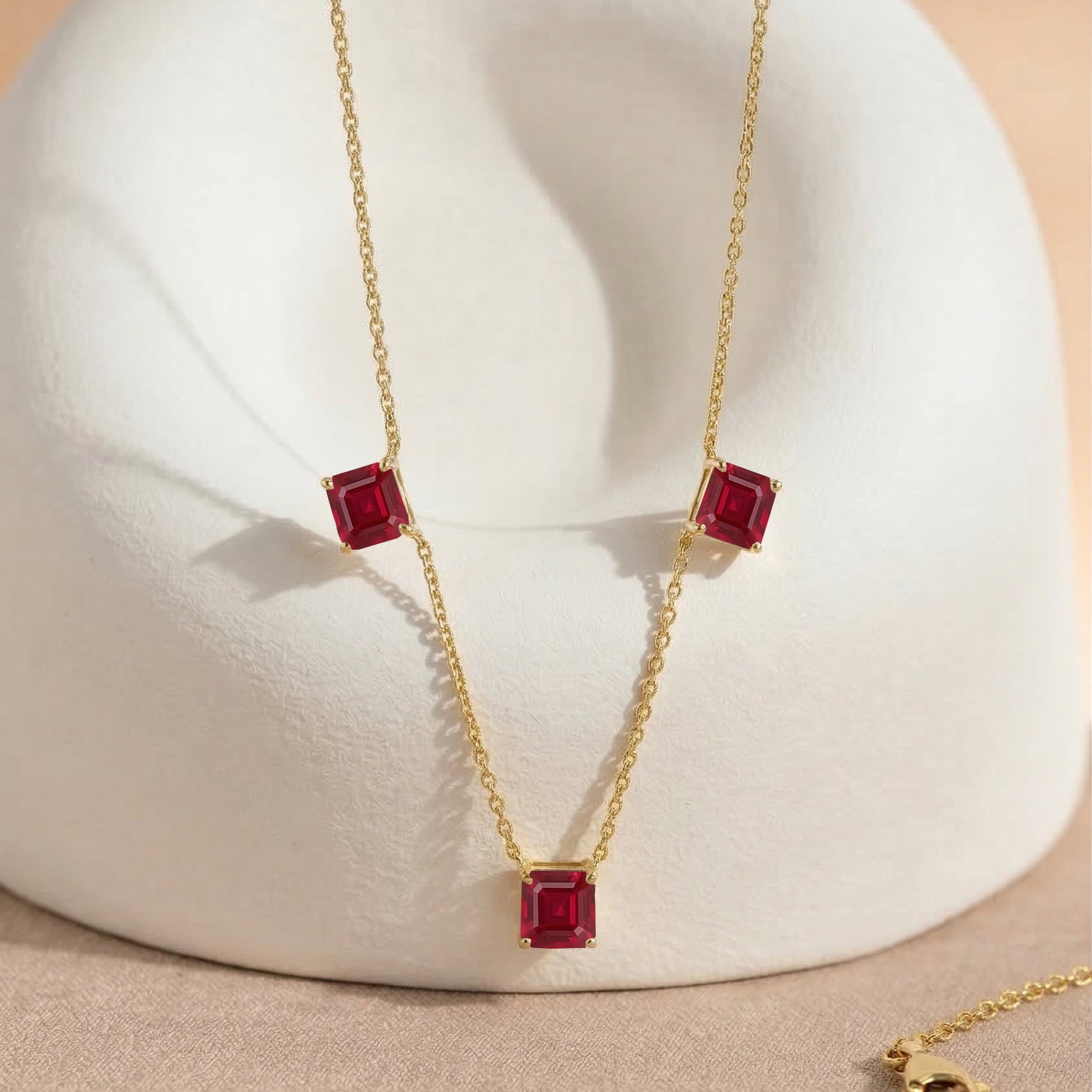 Dainty Ruby gemstone necklace with Asscher cut stones and yellow gold filled finish for women.
