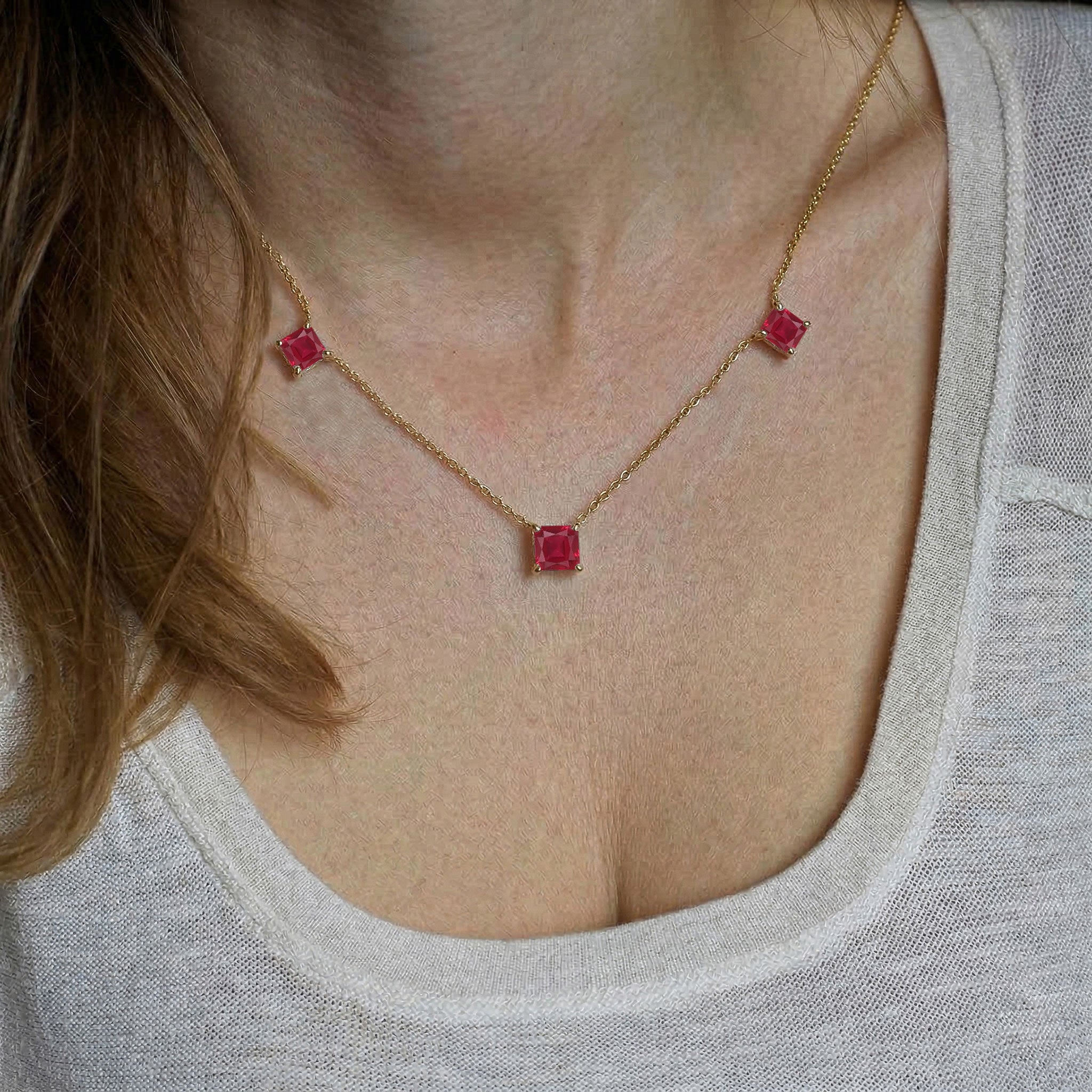 Women's Ruby station necklace featuring rich red gemstones with luxury gold filled chain.
