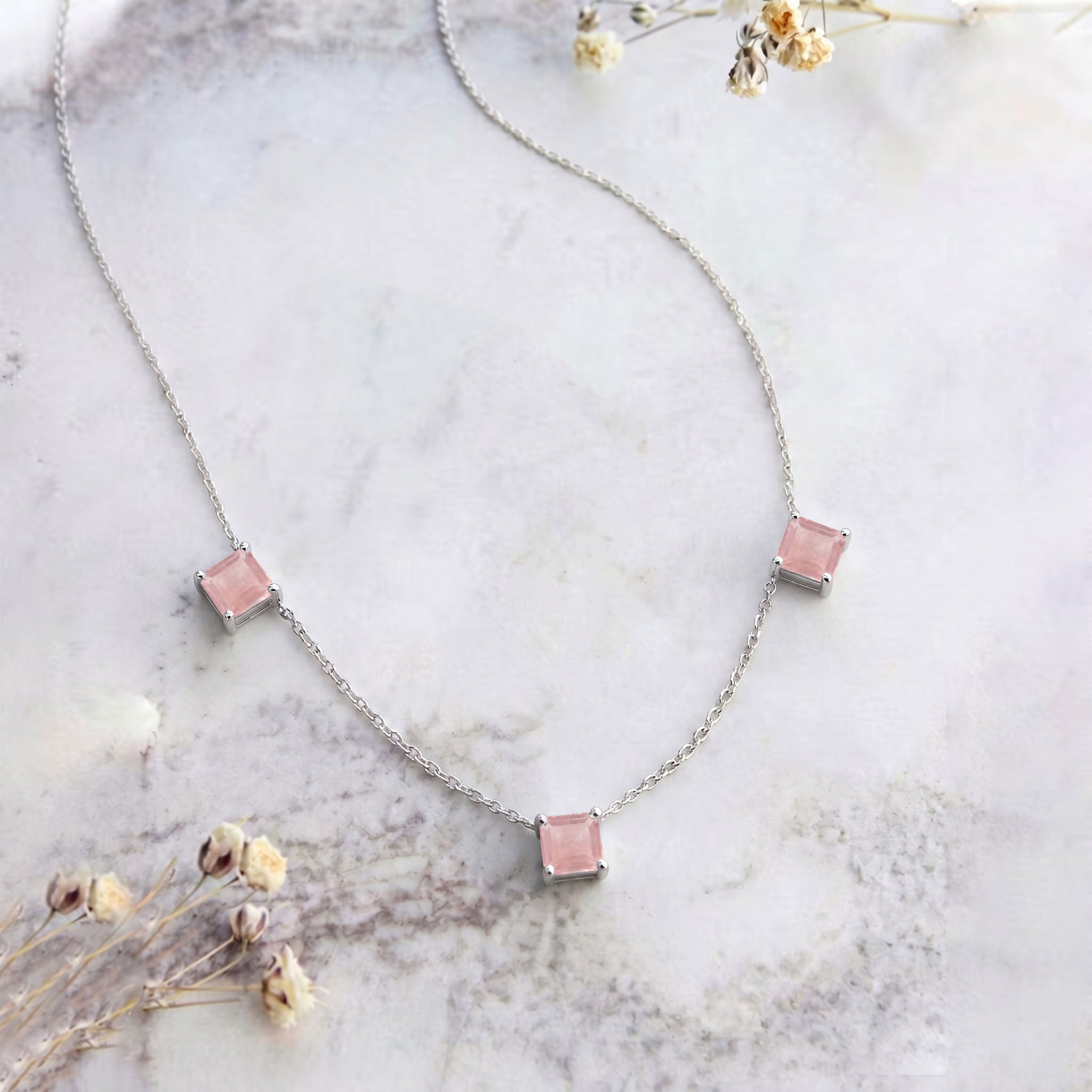 Dainty Rose Quartz gemstone necklace with three Asscher cut stones and yellow gold filled finish.
