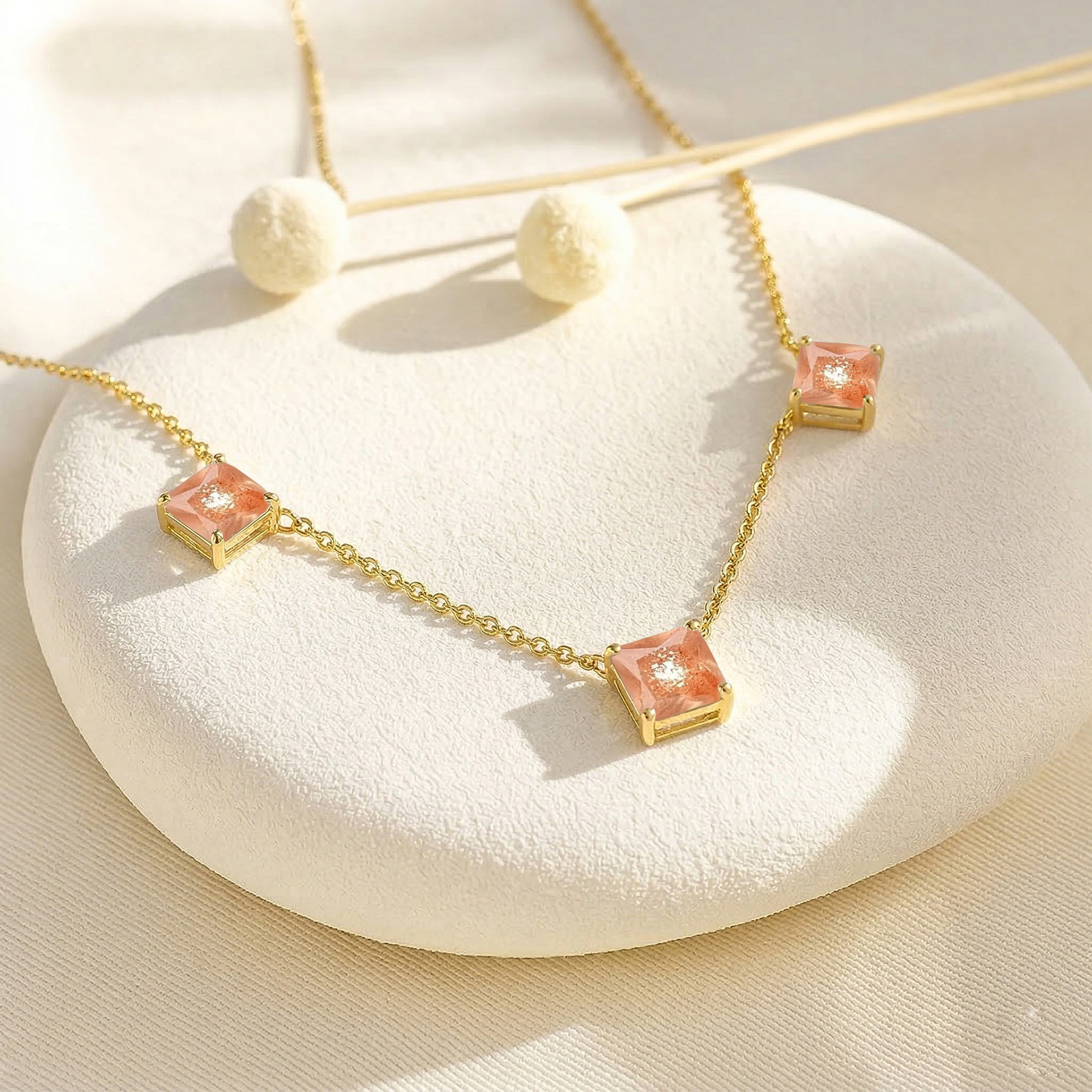 July birthstone Sunstone necklace with elegant three stone design for women.
